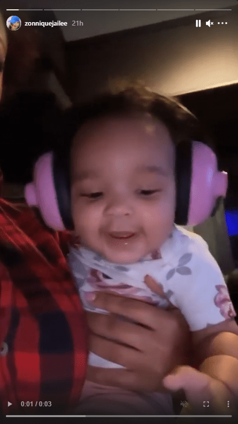 Zonnique Pullins shows off her daughter smiling with pink headphones on. | Photo: Instagram.com/zonniquejailee