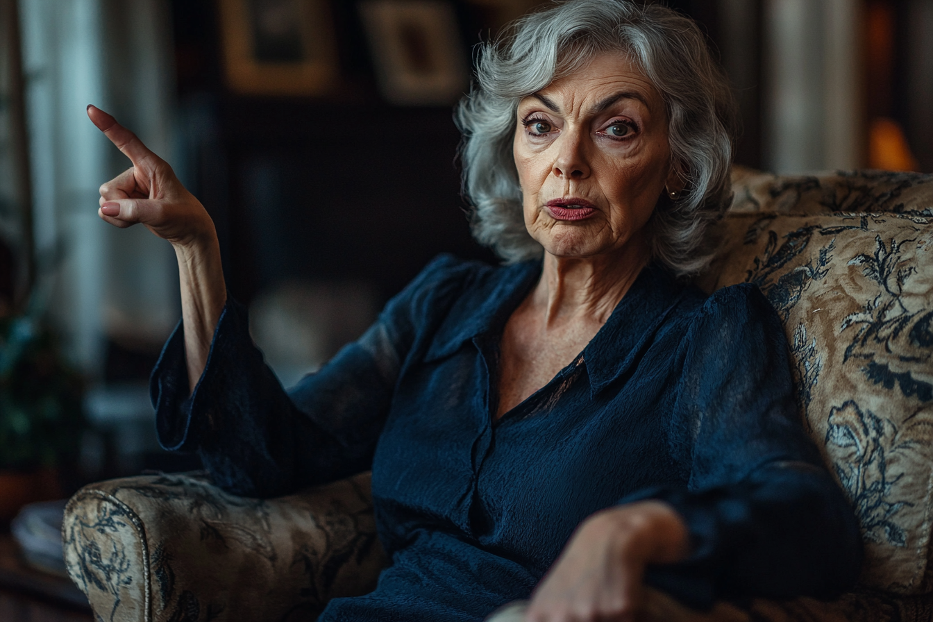 A woman looking angry on an armchair | Source: Midjourney