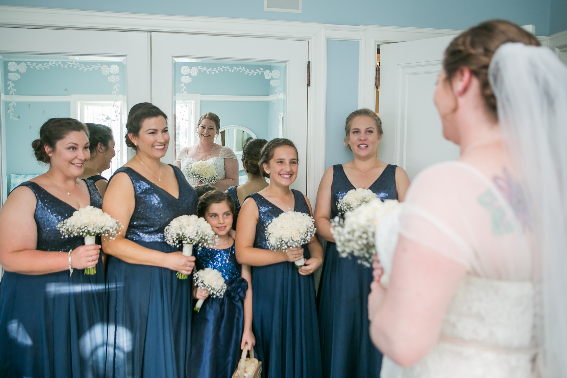 A young bridesmaid standing with other bridesmaids in front of the bride | Source: Pexels