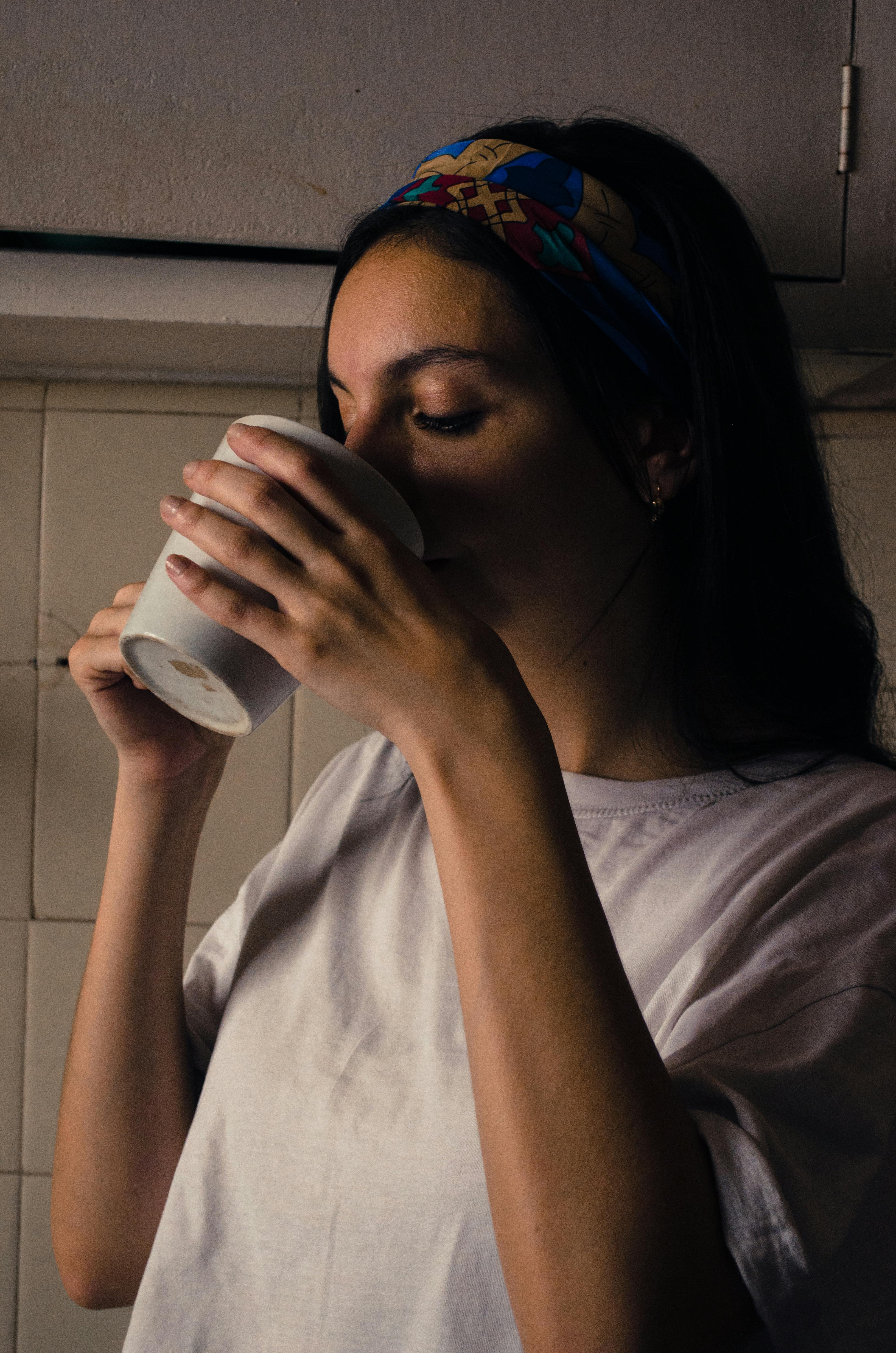A woman drinking tea from a mug | Source: Pexels
