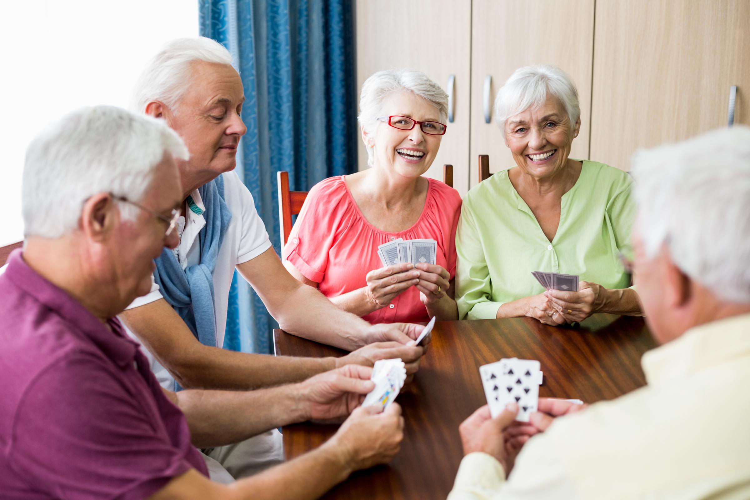 A group of seniors bonding over a card game | Source: Shutterstock