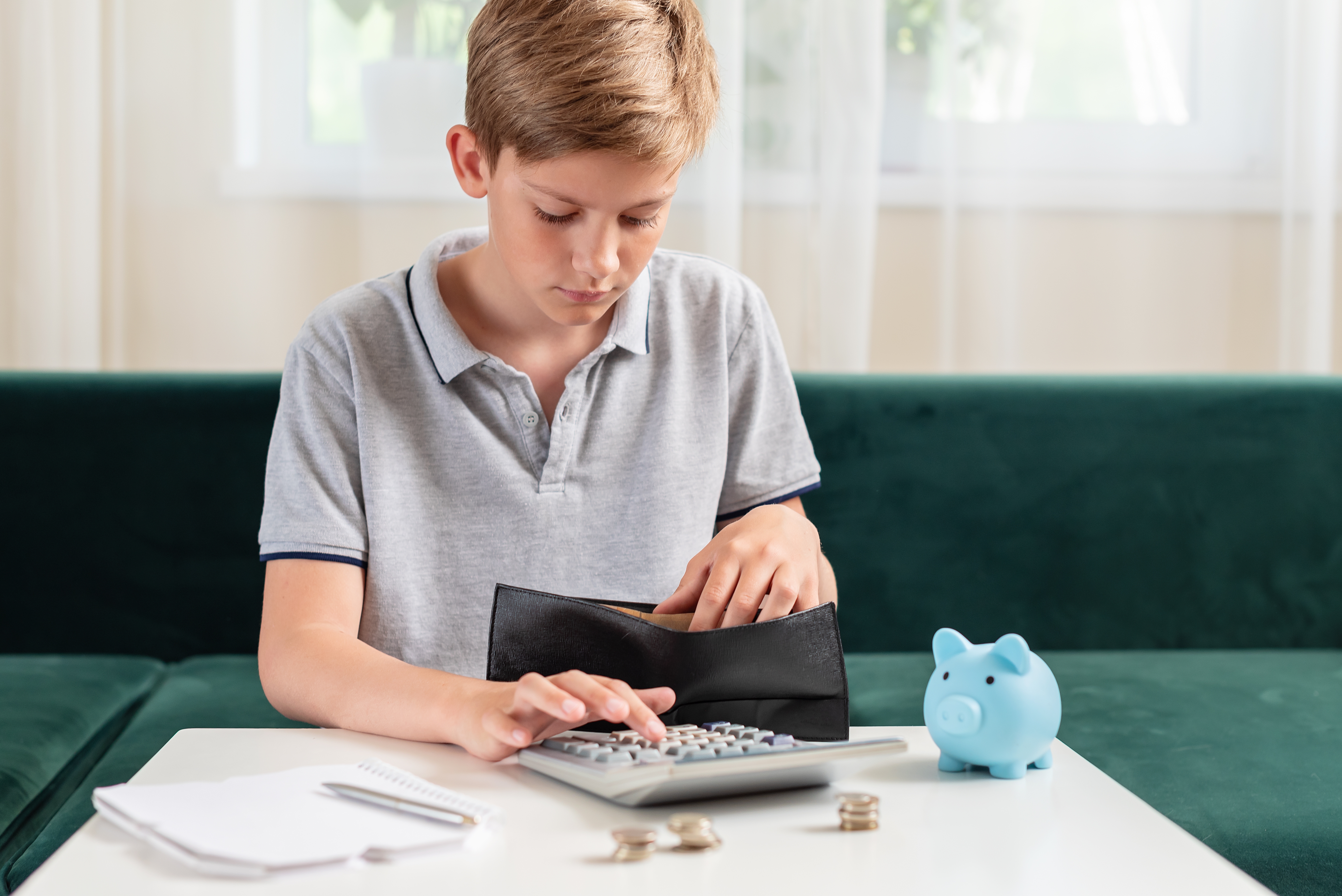 A young boy calculating his money | Source: Shutterstock