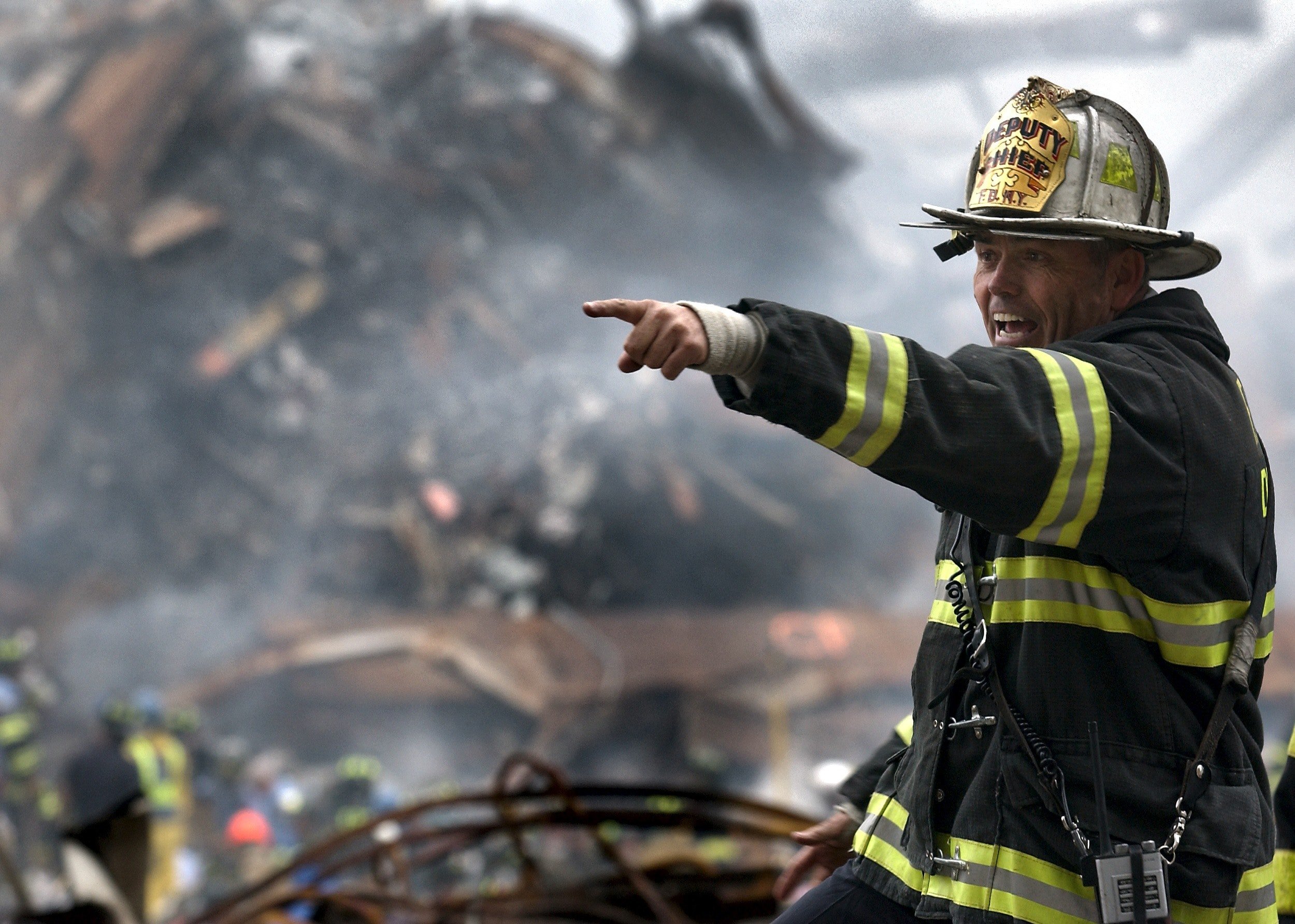 Pictured - A firefighter wearing a black and yellow uniform pointing | Source: Pexels 