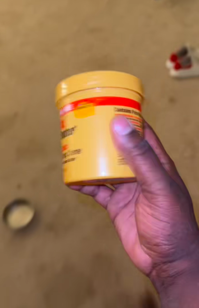 Marquay Collins showing cocoa butter-based lotion he tried on his feet. | Source: TikTok/@marquaythegoat