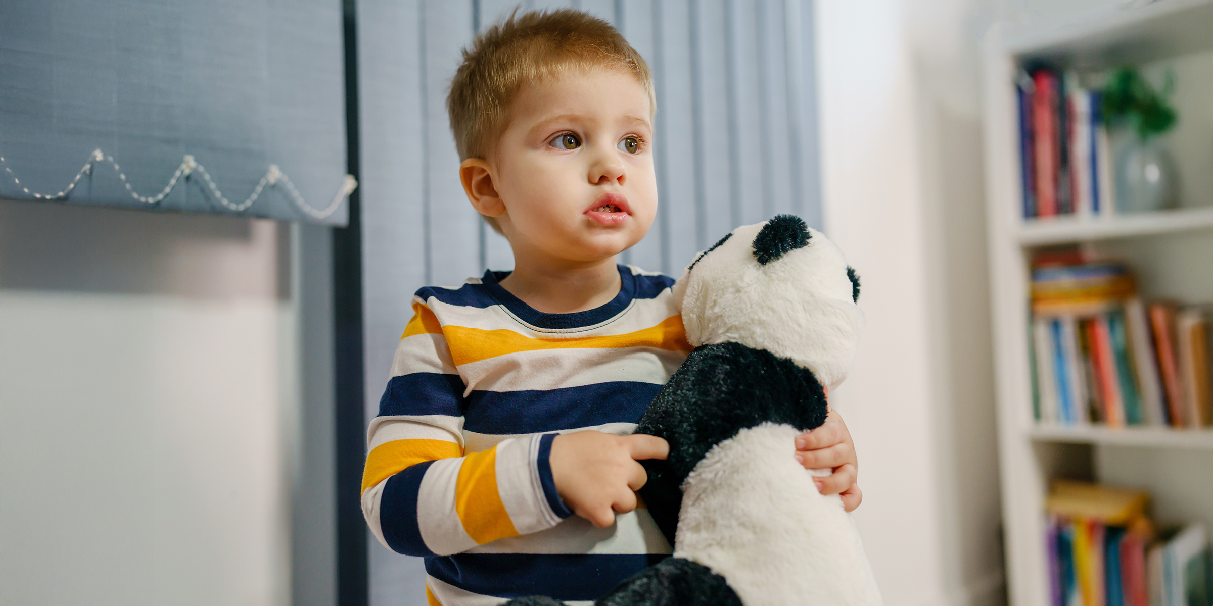 A boy holding a teddy bear | Source: Shutterstock