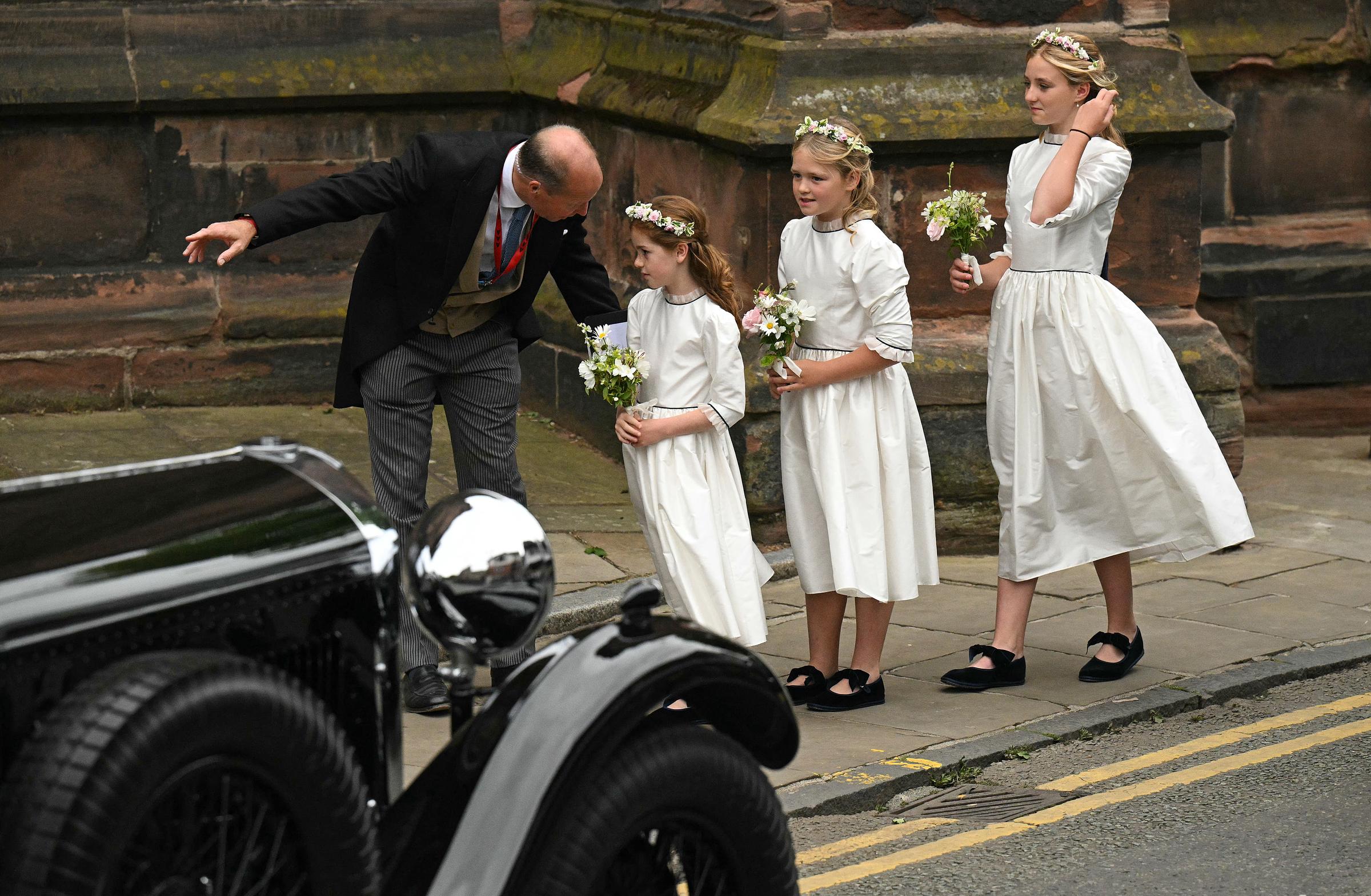 Bridesmaids are directed as they arrive to attend the wedding of the Duke of Westminster and Olivia Henson, at Chester Cathedral in northern England on June 7, 2024 | Source: Getty Images