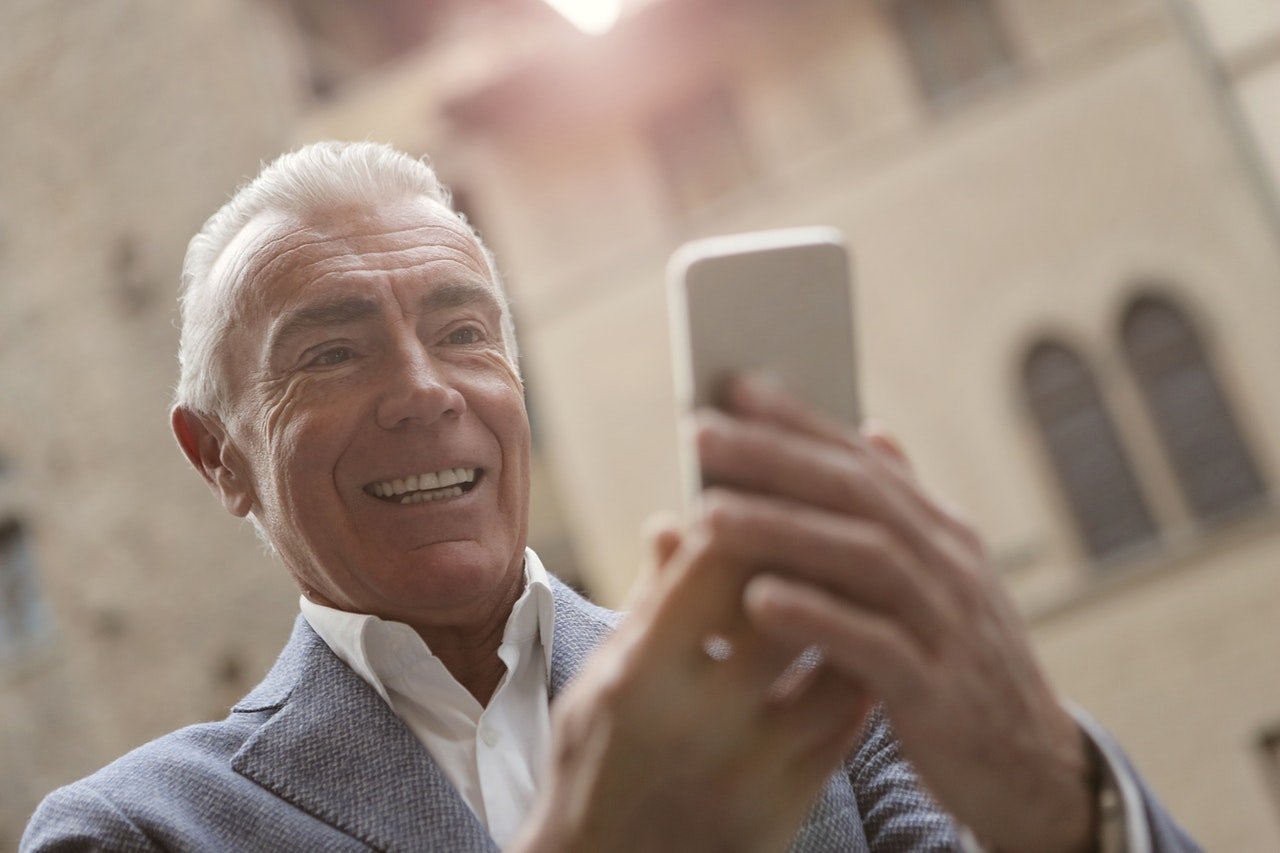 Elderly Man Using Smart Phone To Communicate To His Family by Andrea Piacquadio| Photo:  Pexels