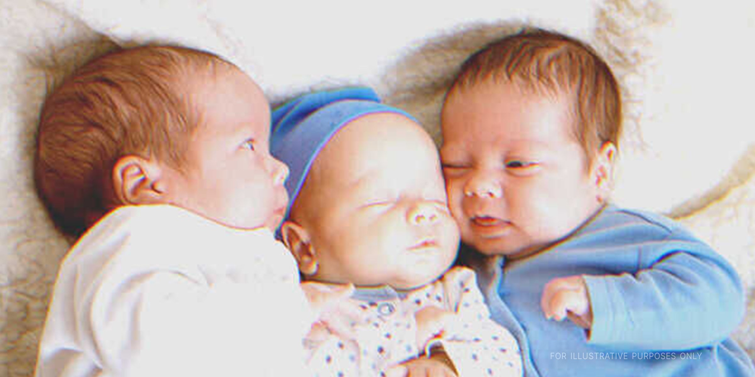 Three newborn babies cuddling with each other | Source: Getty Images