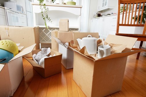 Moving boxes packed with belongings. | Source: Shutterstock.