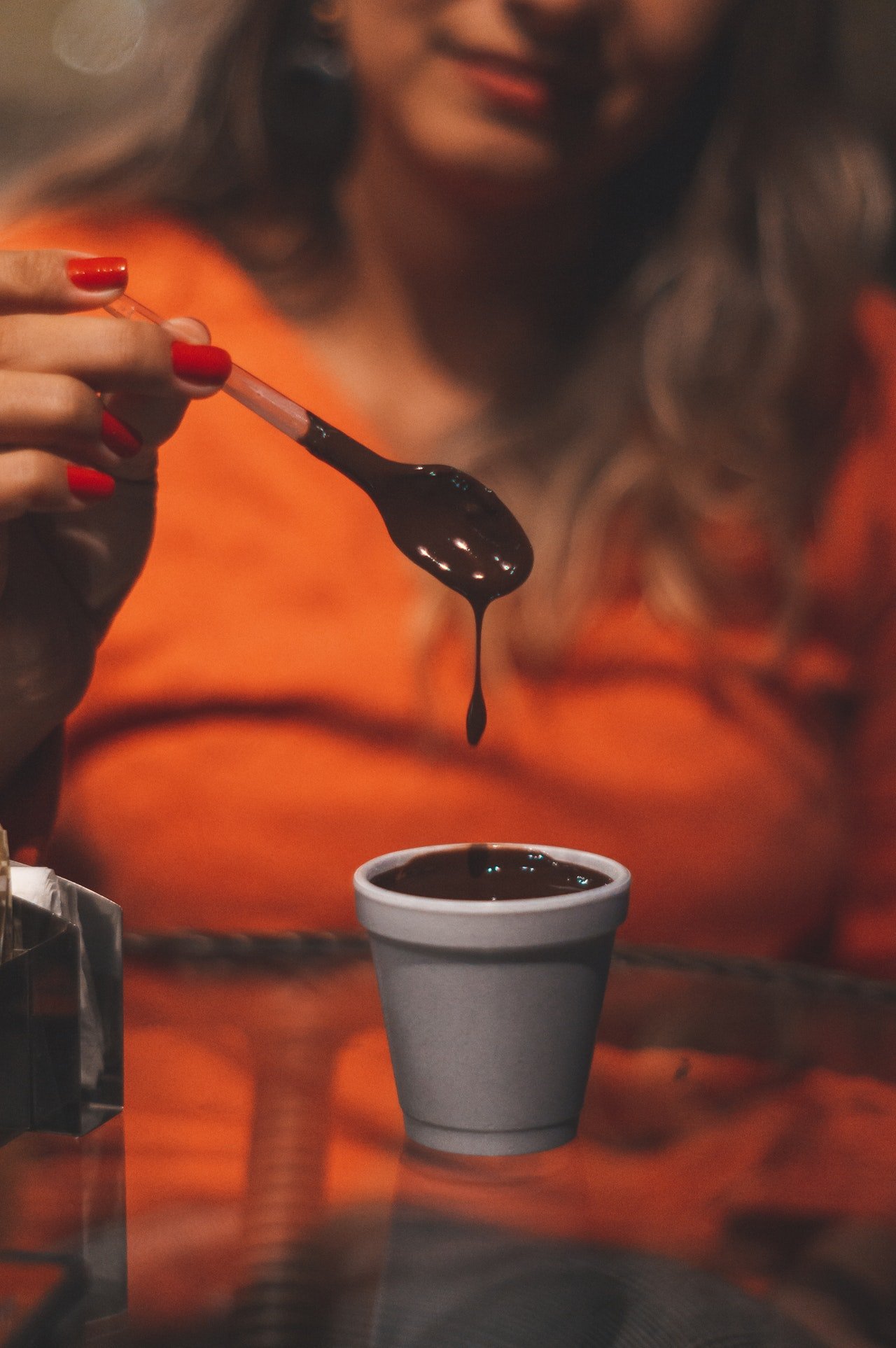 Photo of a woman with a chocolatey drink | Photo: Pexels