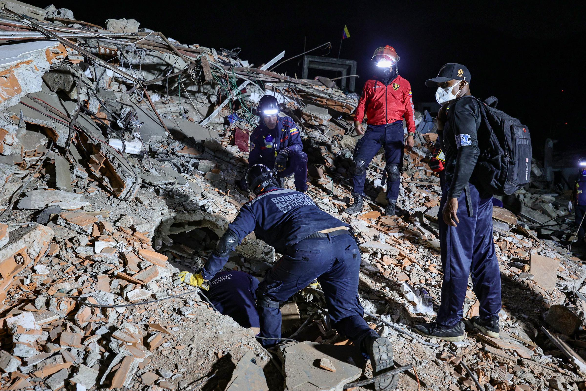 Rescue crews search through the rubble in La Guaira after the powerful earthquakes destroyed buildings across the area. Lucas Trejo spent nearly three days at sites like this, hoping rescuers would find his wife and two children alive. | Source: Getty Images