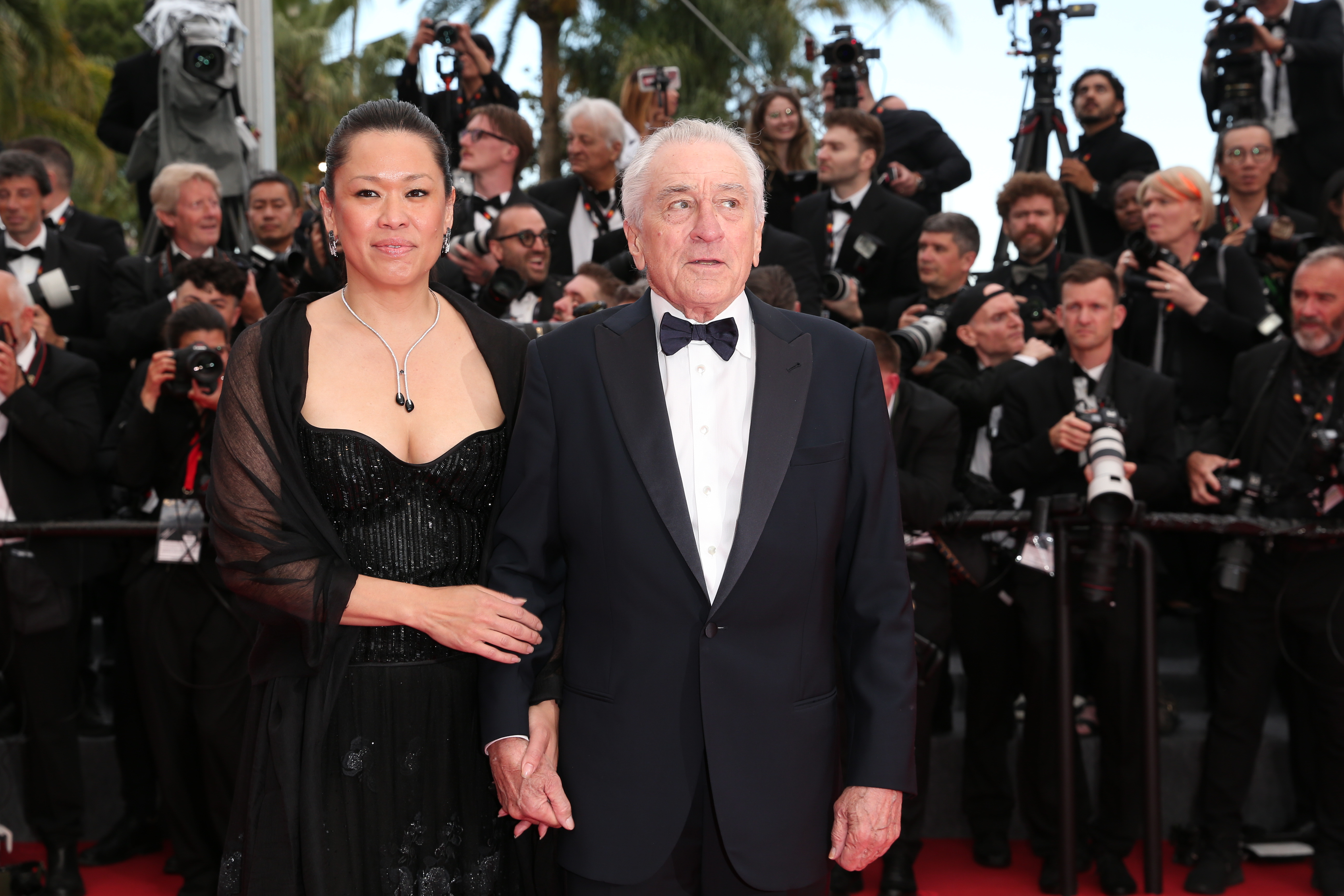 Robert De Niro and Tiffany Chen attend the red carpet at the 78th annual Cannes Film Festival at Palais des Festivals on May 13, 2025, in France | Source: Getty Images