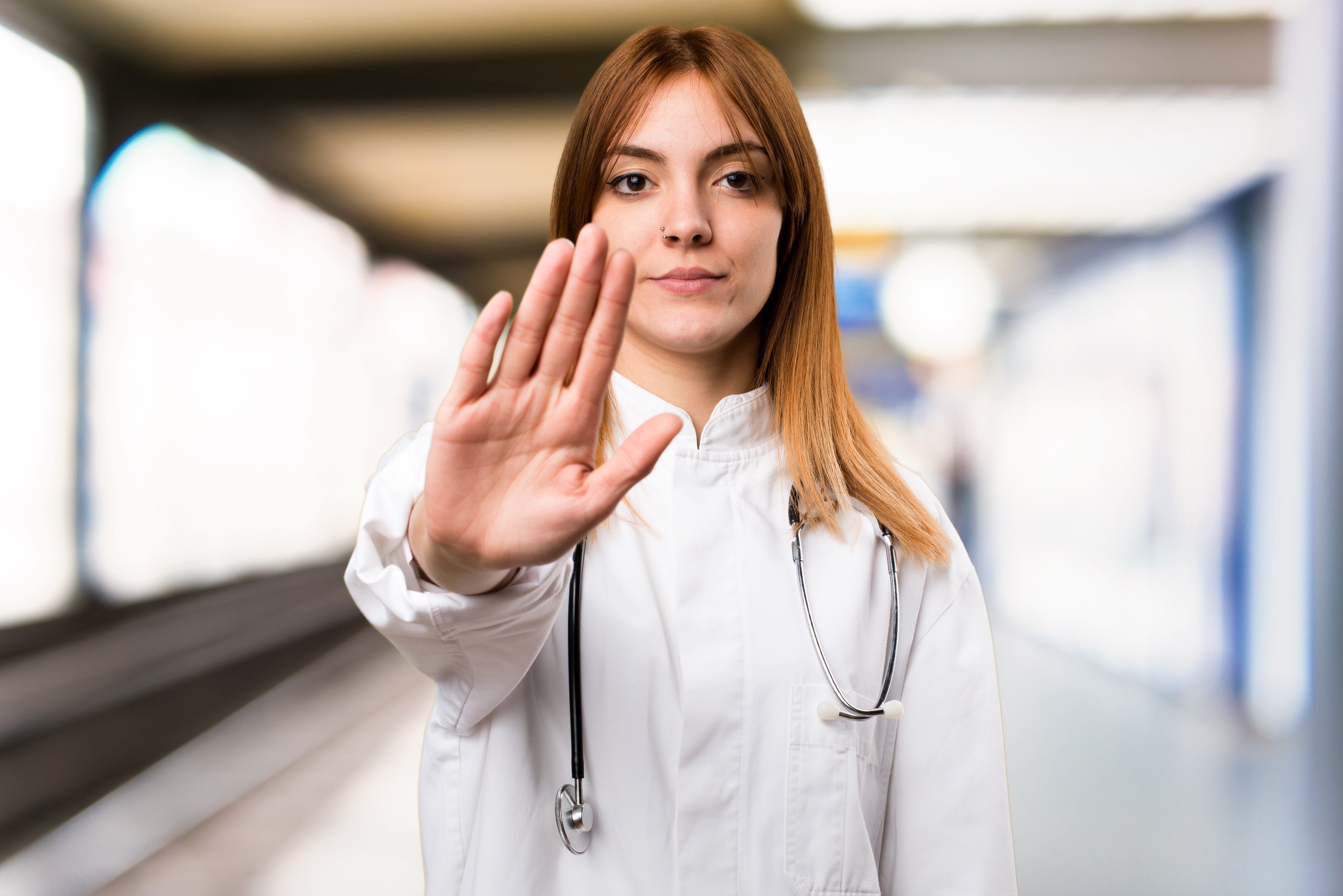 A doctor putting her hand up | Source: Shutterstock