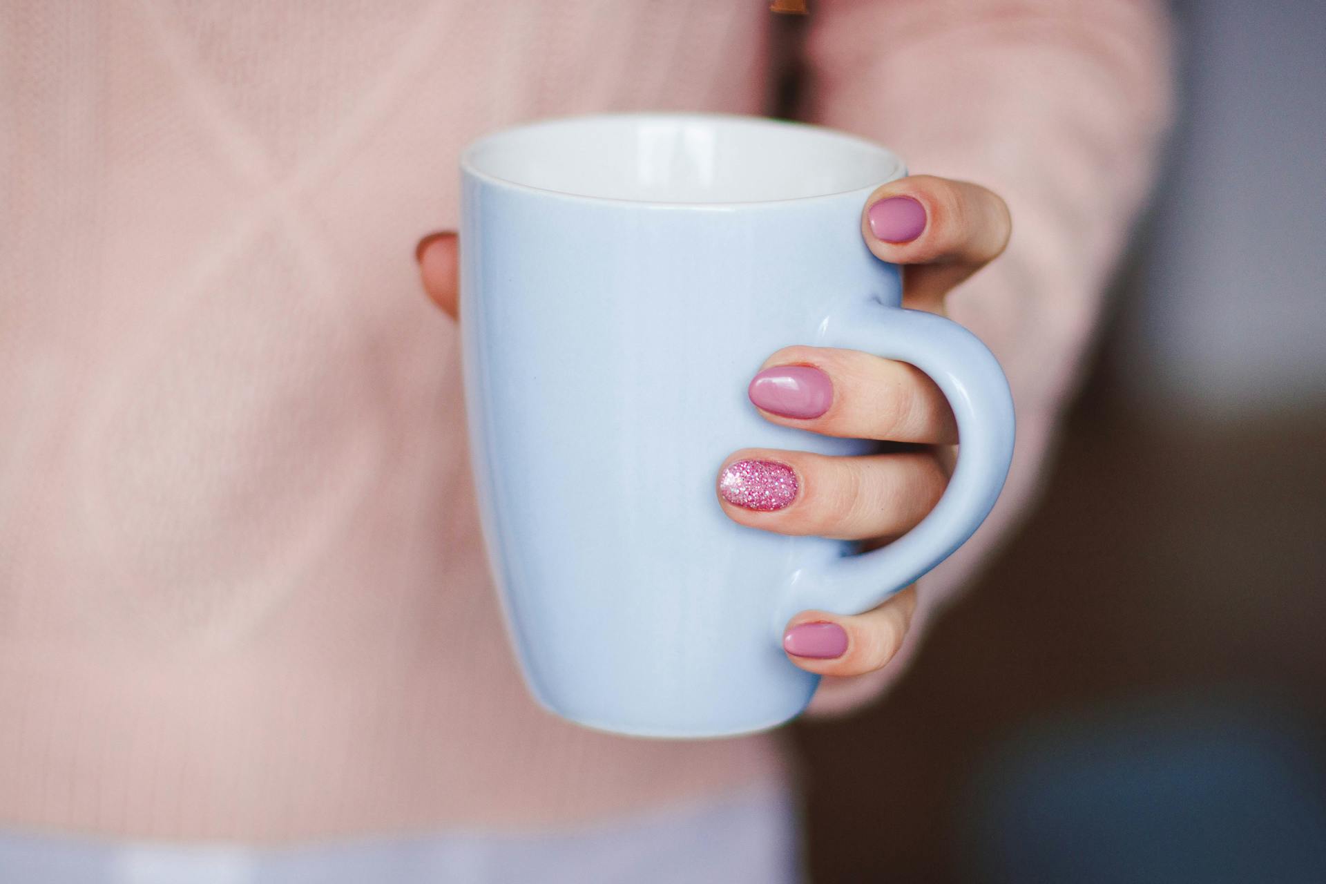 A person holding a white mug | Source: Pexels