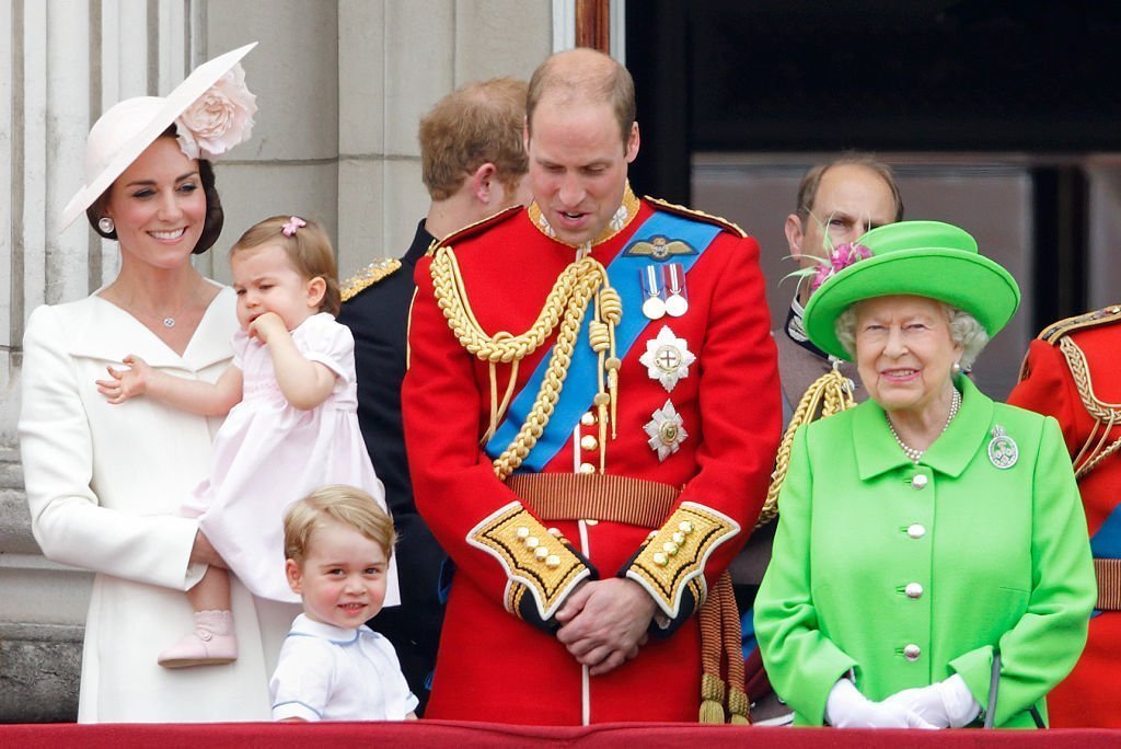 Catherine, Duchess of Cambridge, Princess Charlotte of Cambridge, Prince George of Cambridge, Prince William, Duke of Cambridge and Queen Elizabeth II watch the flypast from the balcony of Buckingham Palace during Trooping the Colour, this year marking the Queen's 90th birthday | Photo: Getty Images