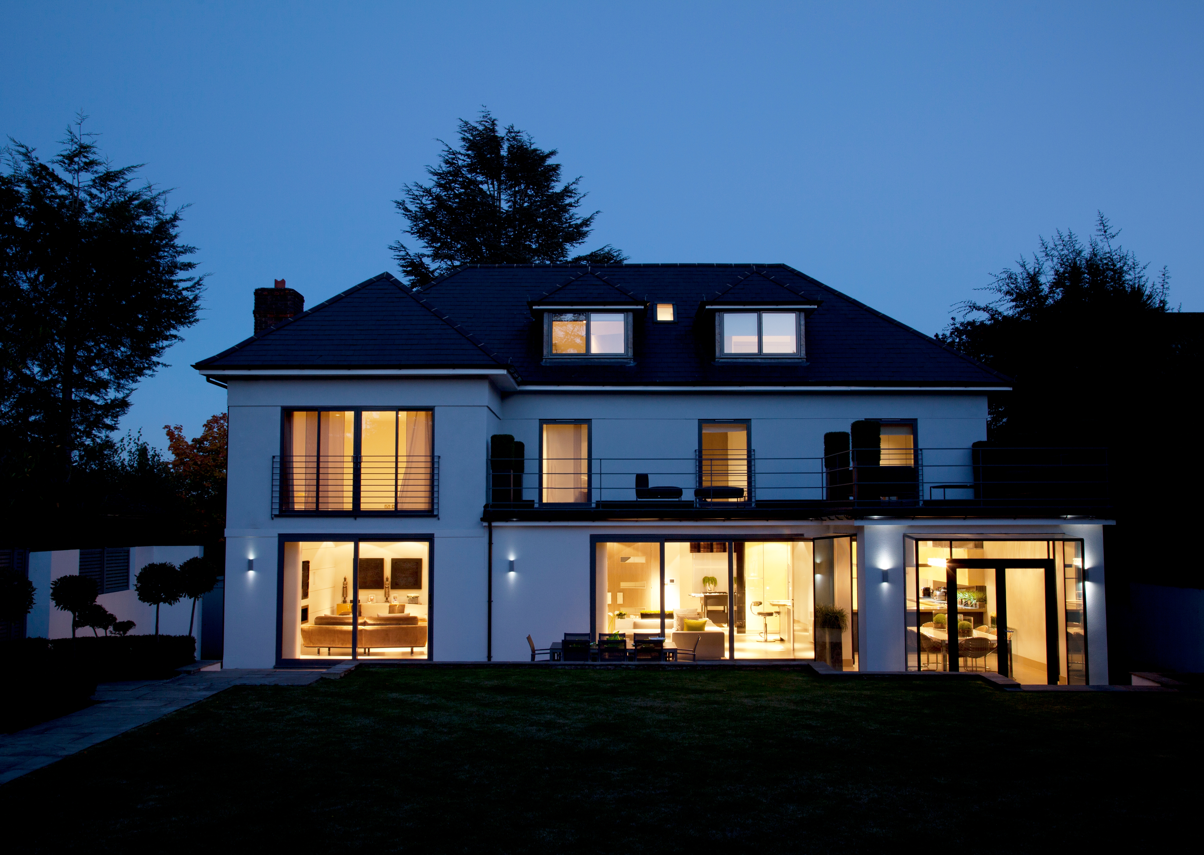 Modern house illuminated at night. | Source: Shutterstock