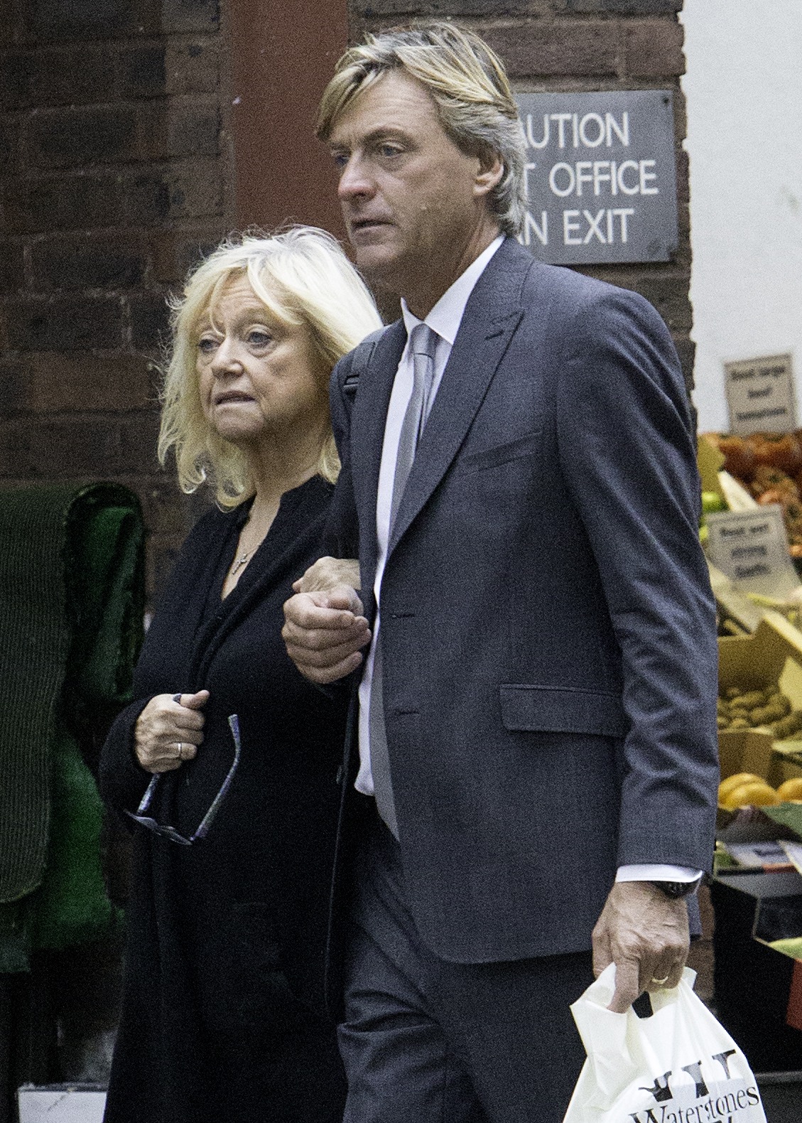 Judy Finnigan and Richard Madeley are seen shopping in Hampstead on 19 October 2017, moving through the street with quiet familiarity as they carry their purchases — a simple, unguarded moment that reflects how their lives have shifted from public figures to a couple embracing the calm of everyday routines together.
