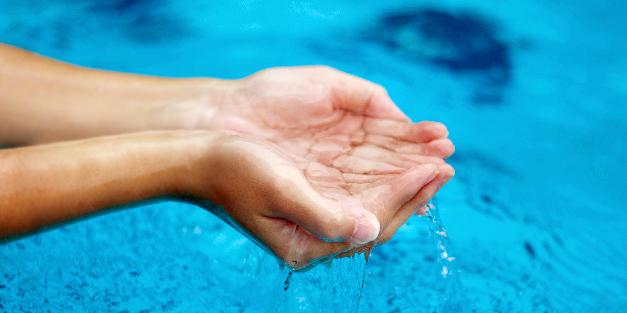 A person putting their hands in water | Source: Shutterstock