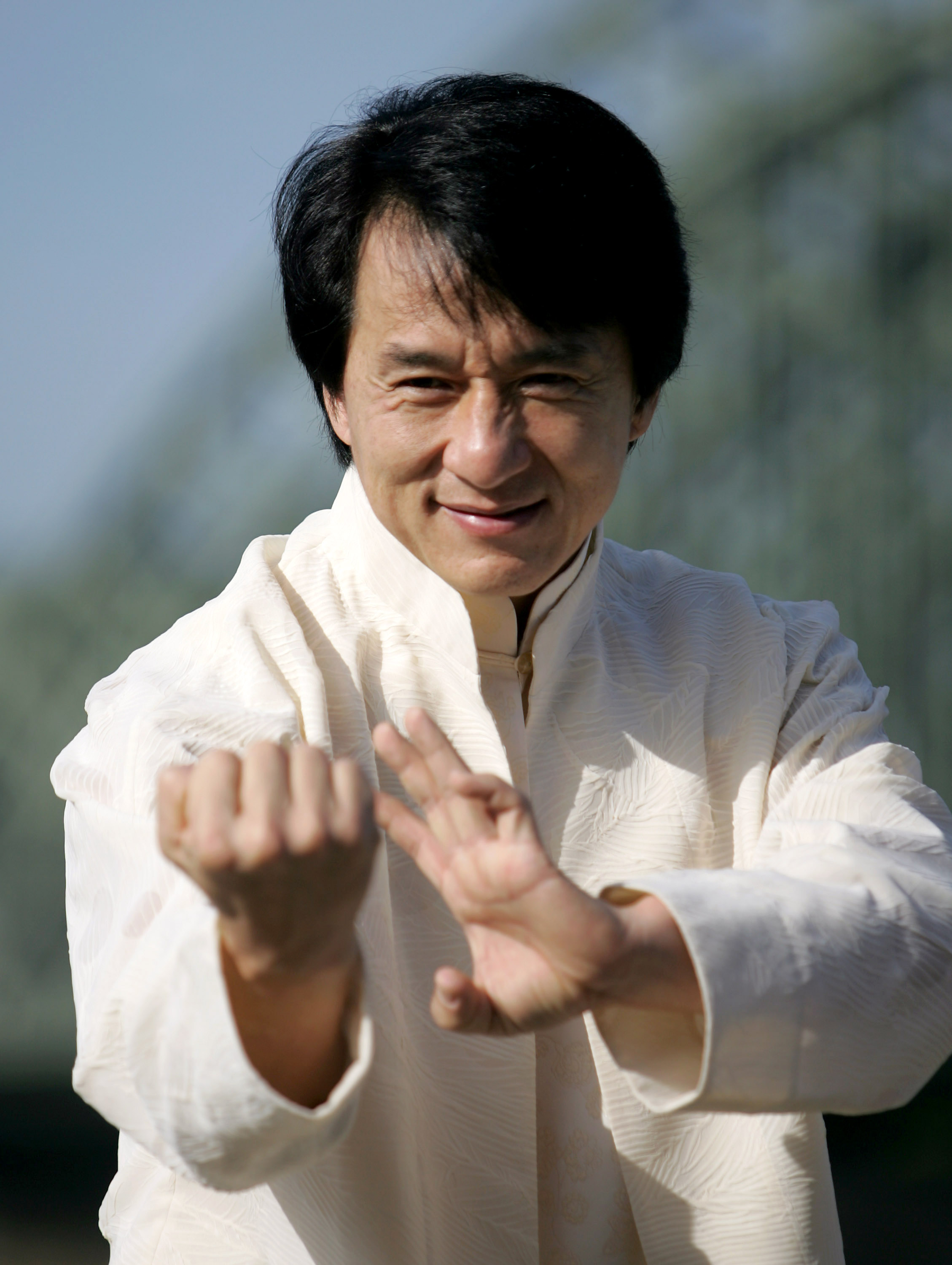Jackie Chan posing for a picture ahead of the premiere of "New Police Story" in Cologne, Germany on October 10, 2005 | Source: Getty Images