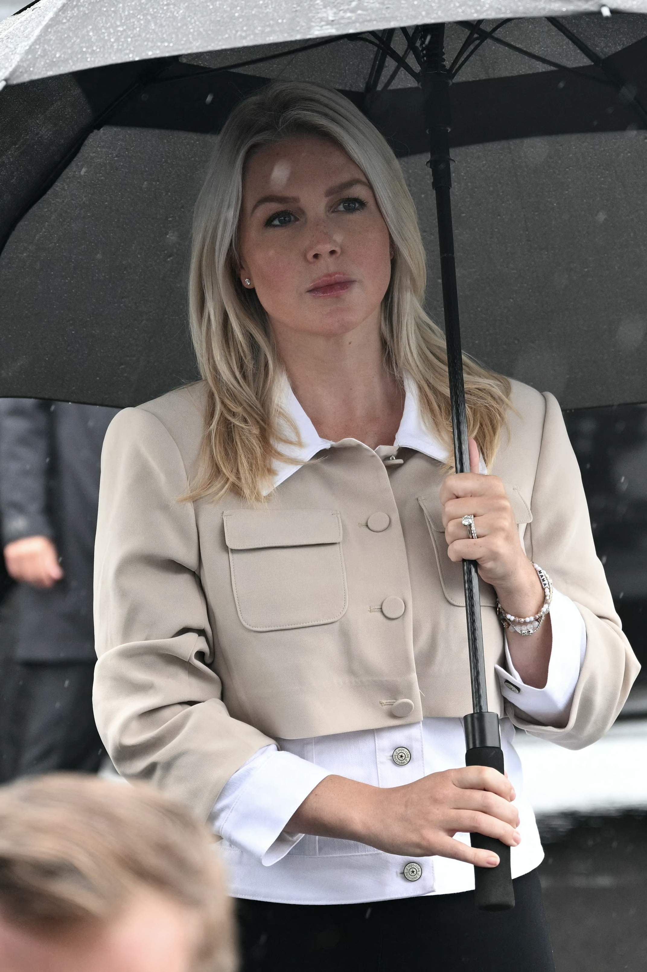She only looked serious in a few shots while holding her umbrella under the drizzling rain. | Source: Getty Images