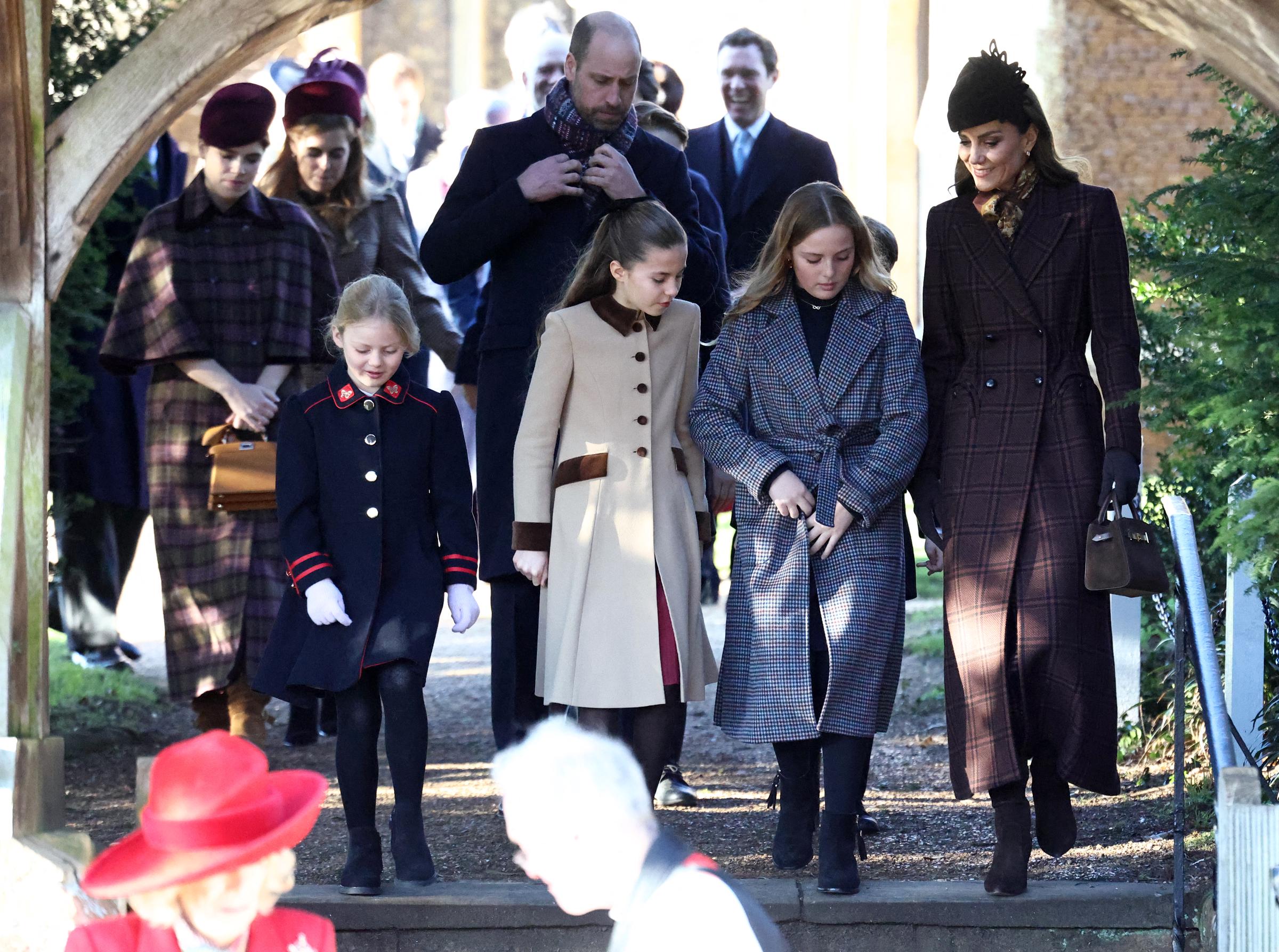 William, Prince of Wales, adjusts his scarf as he walks behind his family following the Royal Family's traditional Christmas Day service at St Mary Magdalene Church on the Sandringham Estate on December 25, 2025. Catherine, Princess of Wales, walks ahead while Princess Eugenie and Princess Beatrice follow nearby, a moment that later sparked discussion among royal watchers.