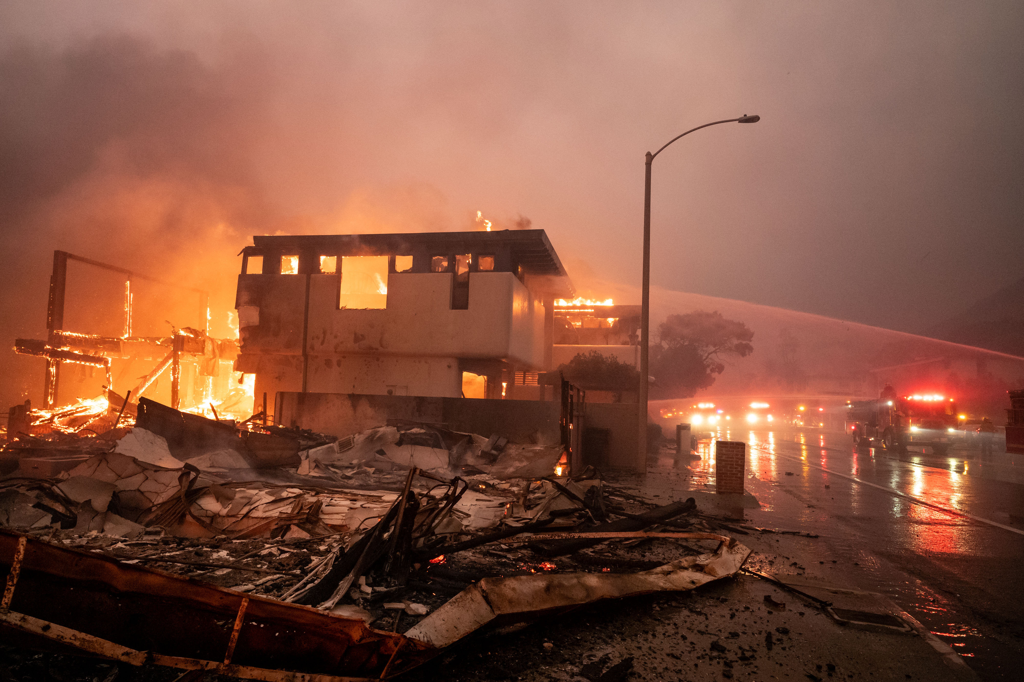 Firefighters continue to battle wind and fire as homes go up in flames in Malibu along Pacific Coast Highway in the Palisades Fire on January 8, 2025 | Source: Getty Images