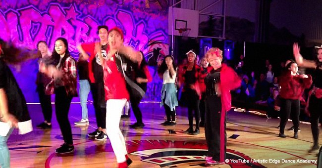 Students prepare to do a youthful dance, but their 60-year-old teacher steals the spotlight