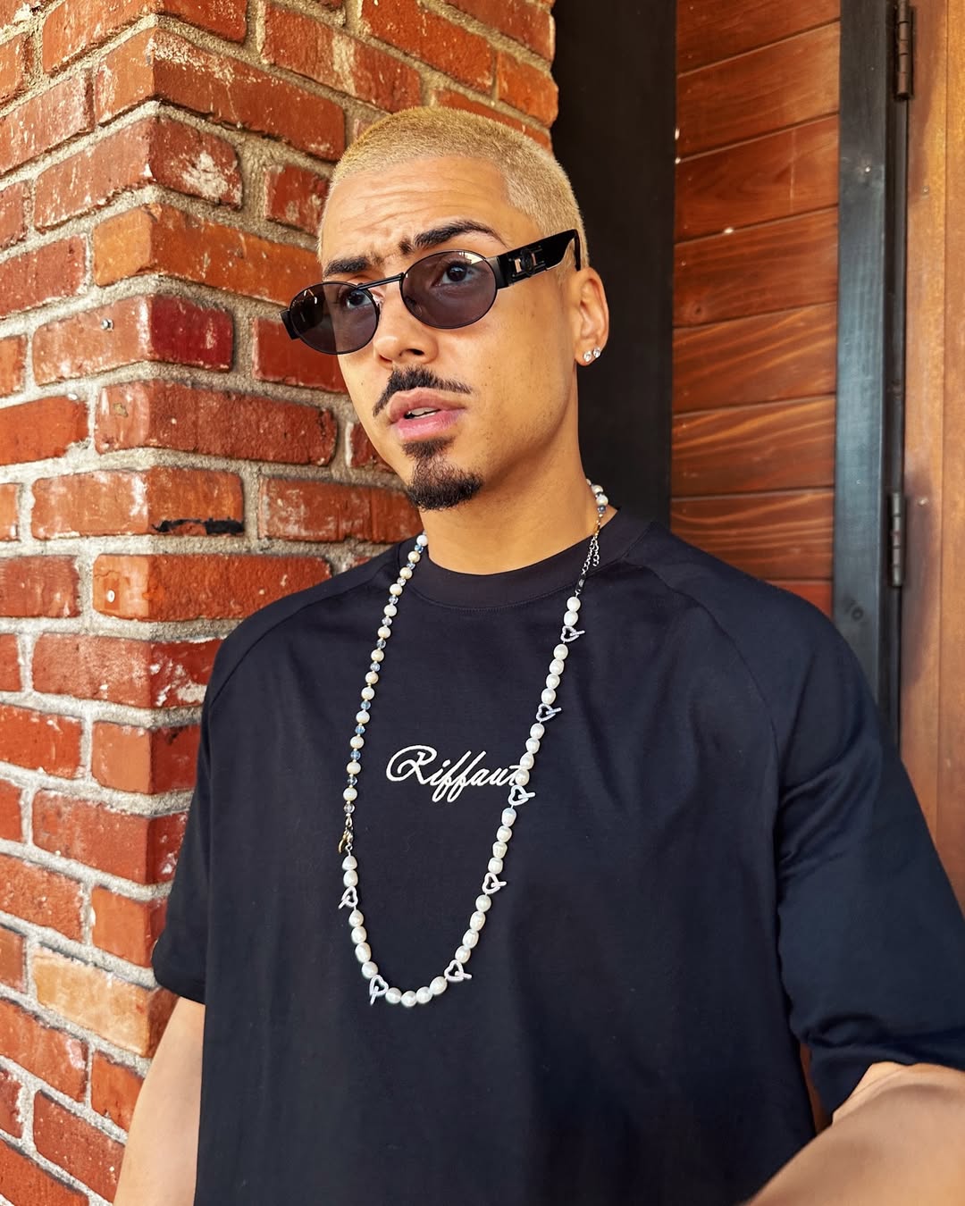 Quincy Brown pictured standing outside, dated July 2024 | Source: Instagram/quincy
