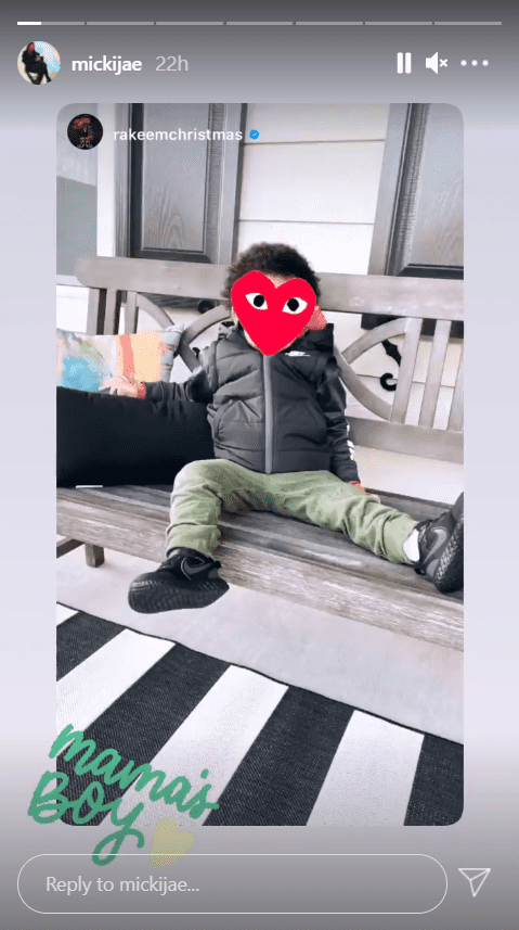 A picture of Jasmine Jordan's son, Rakeem, seated on a bench with his face covered with a red heart emoji and accompanied with a caption | Photo: Instagram/mickijae