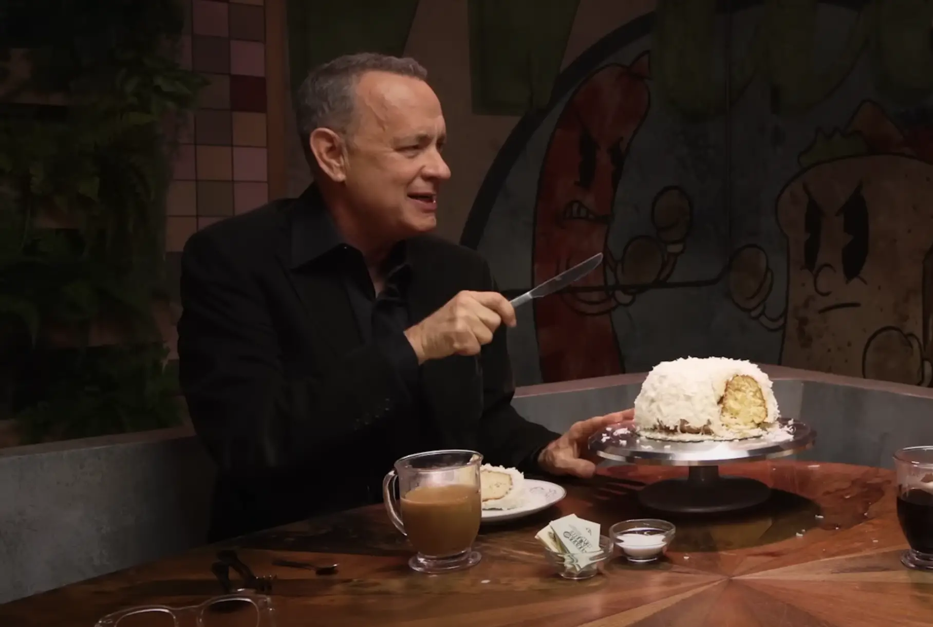 Tom Hanks showing off Doan's Bakery's Bunt cake which he receives as a Christmas gift from Tom Cruise. The cake was shown on Mythical Kitchen on January 19, 2023 | Source: YouTube/Mythical Kitchen