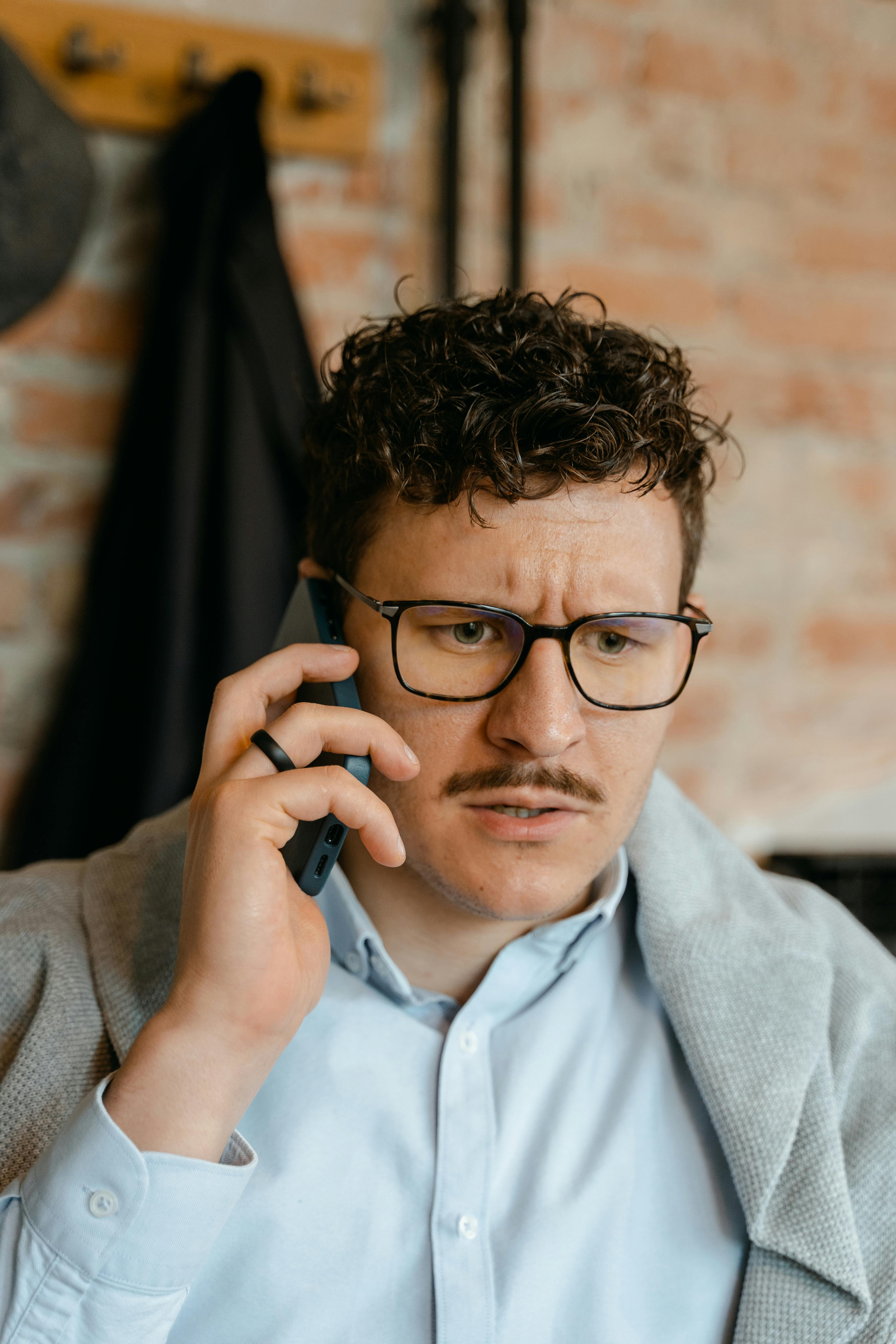 An unhappy man on a call | Source: Pexels