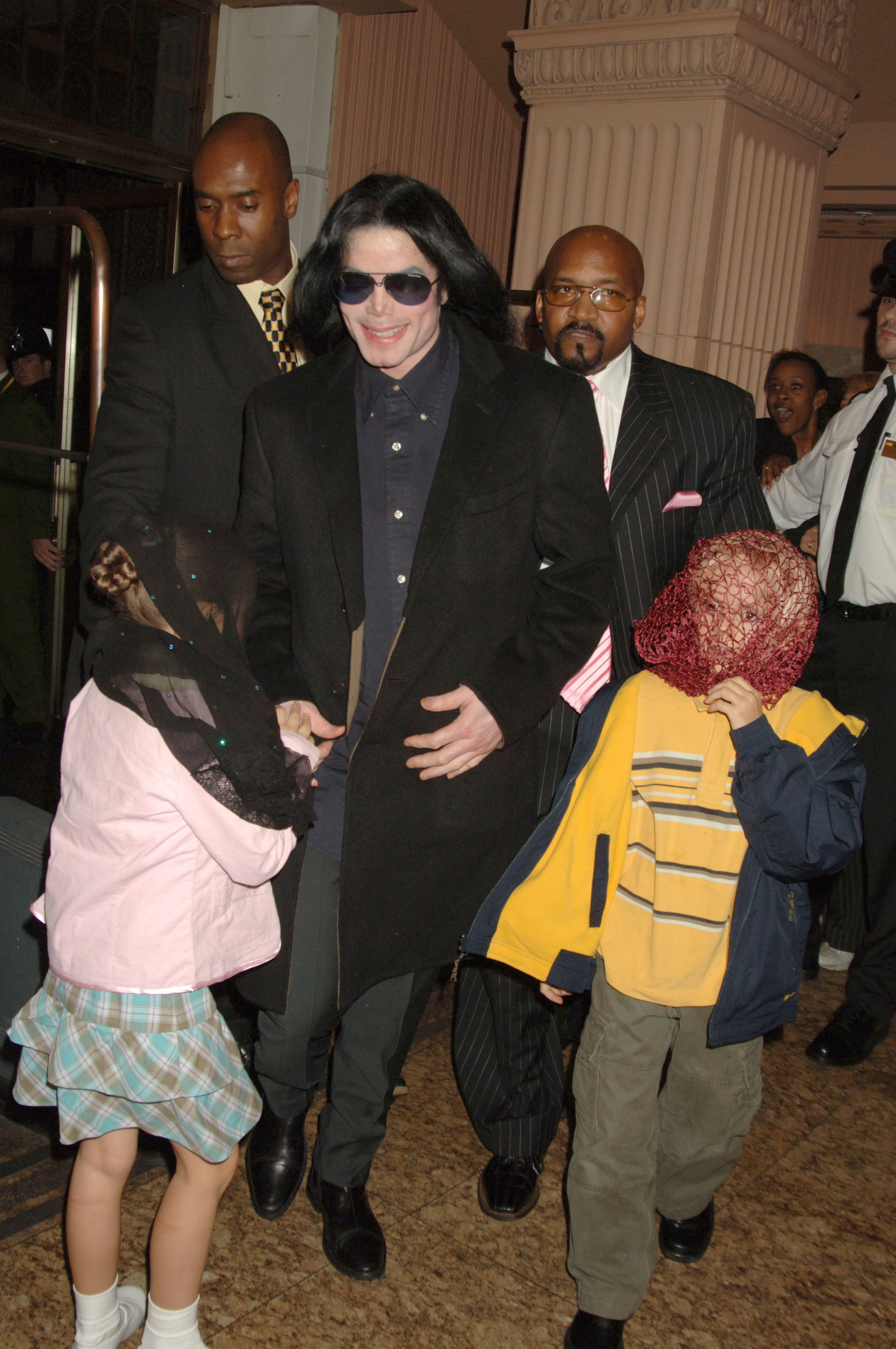 Michael Jackson walks with his children, Prince and Paris, during a visit to Harrods in London, England, on October 12, 2005 | Source: Getty Images