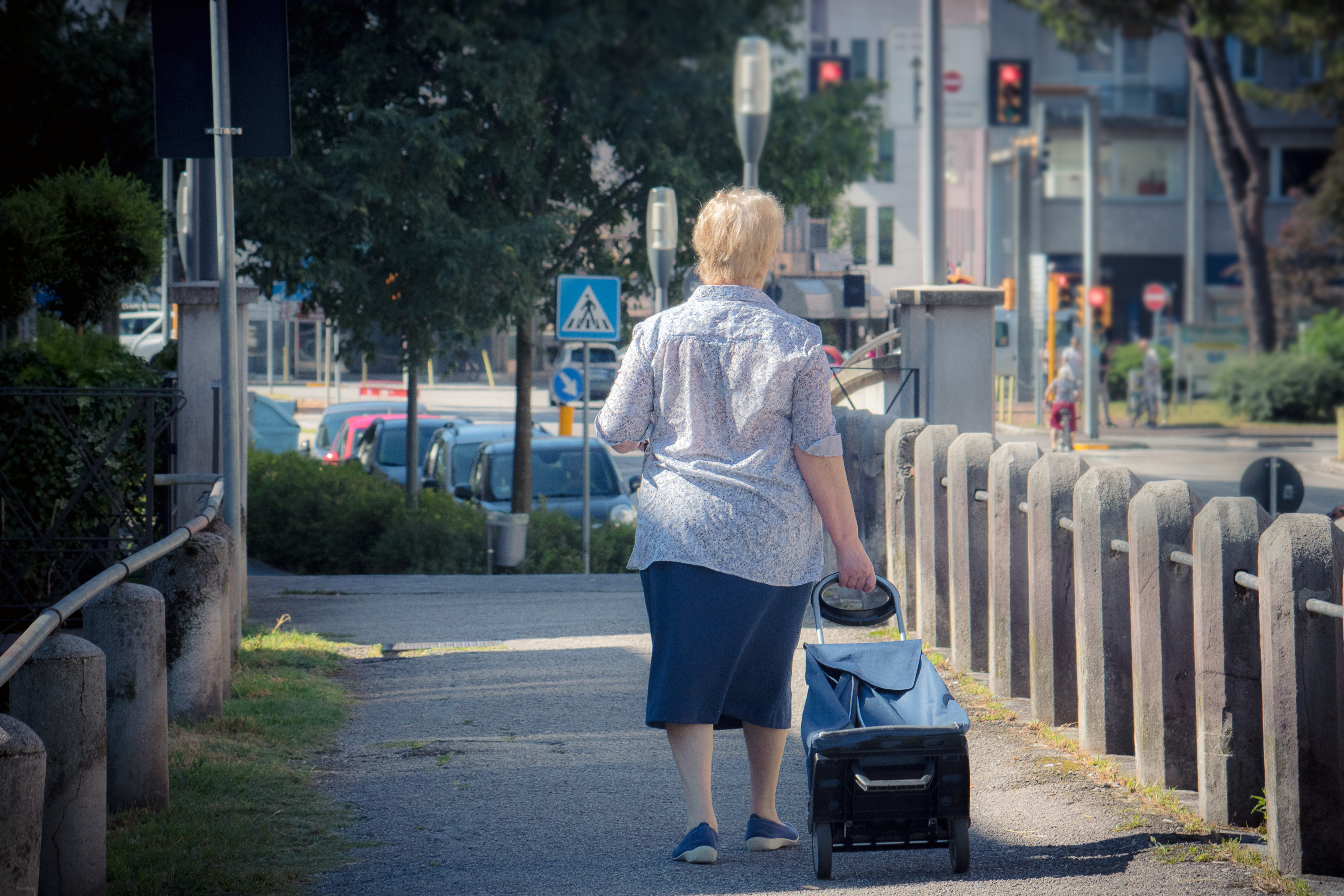 A woman walking with a trolley bag | Source: Shutterstock