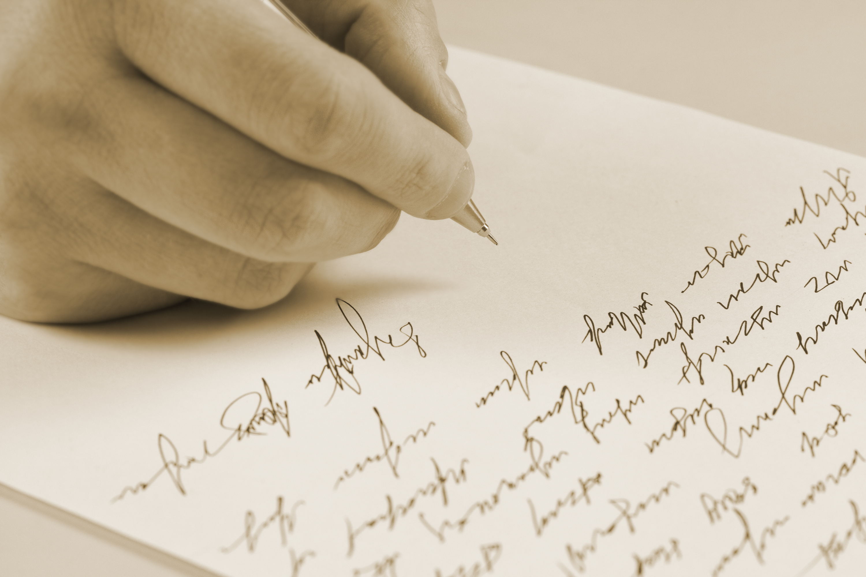 Male hand writing on a paper | Source: Shutterstock