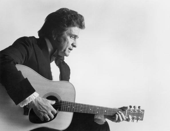  Johnny Cash playing an acoustic guitar, in a promotional still for the 11th annual Country Music Association Awards | Photo: Getty Images