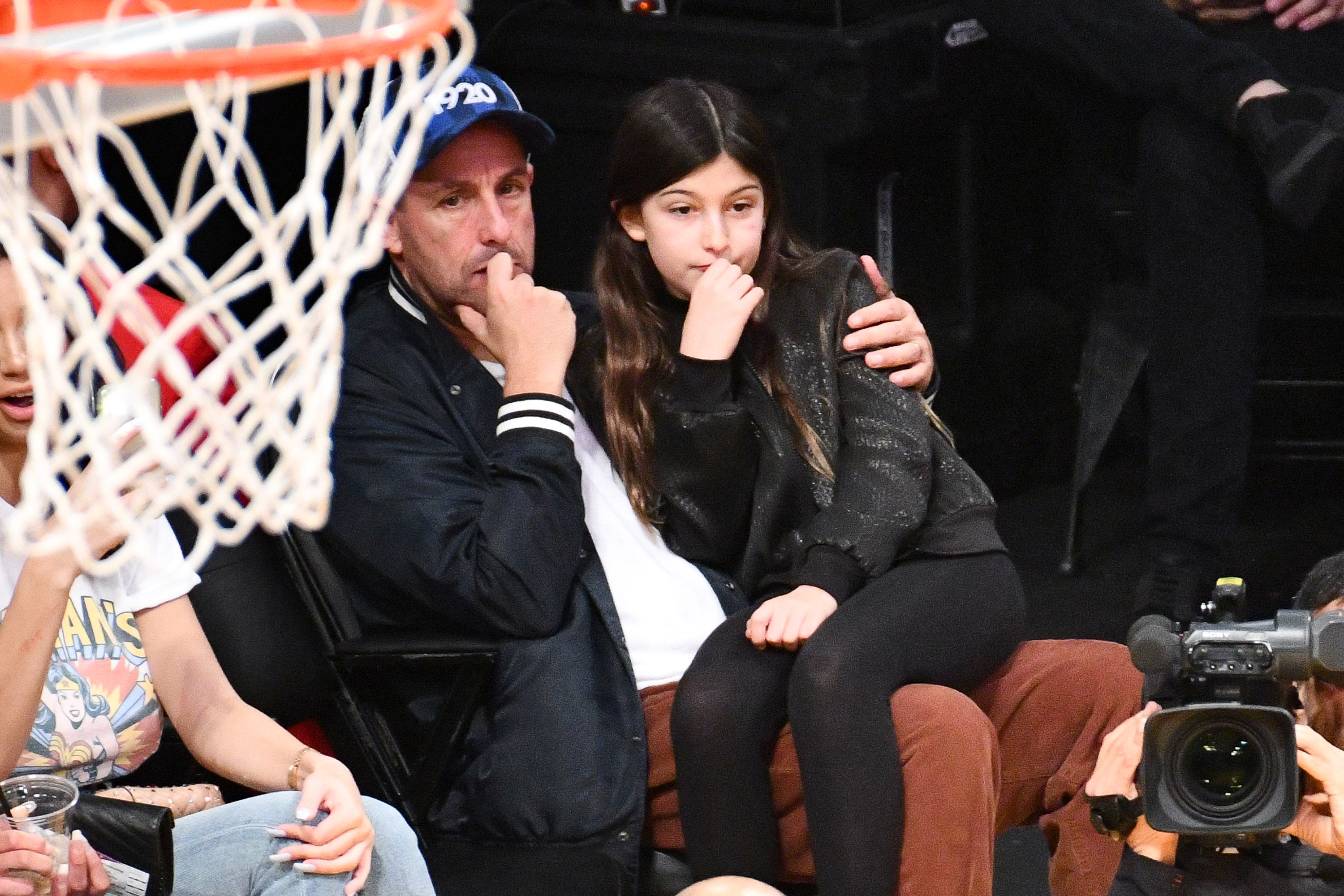 Adam Sandler and daughter Sunny attend a Lakers vs. Trail Blazers game at Staples Center on November 14, 2018 | Source: Getty Images