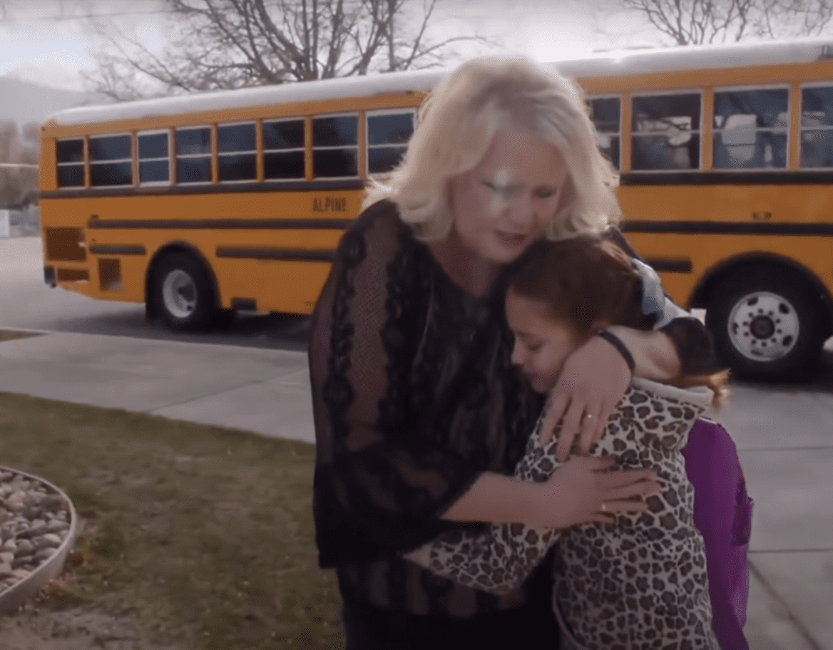 Girl hugs kind bus driver who helped her with her hair. | Source: youtube.com/NBC News