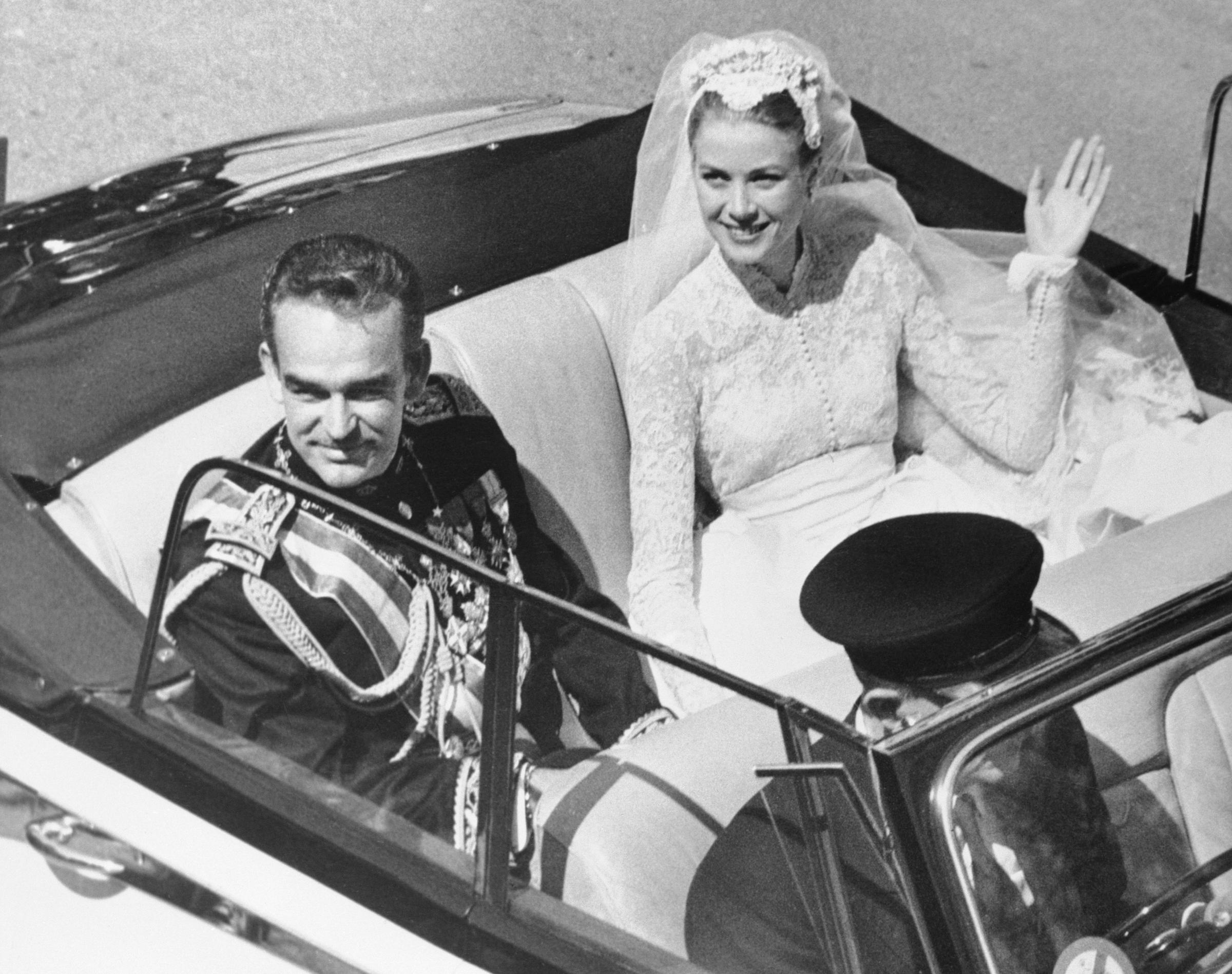 Prince Rainier III and Grace Kelly pictured in open car after their religious wedding on April 19, 1956, in Monaco. | Source: Getty Images