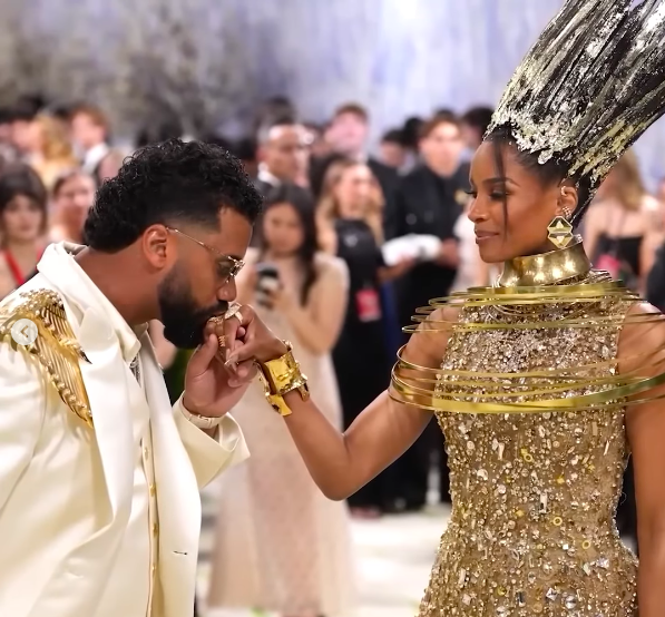 Russell Wilson giving Ciara's hand a kiss as she looks at him. | Source: Instagram/dangerusswilson