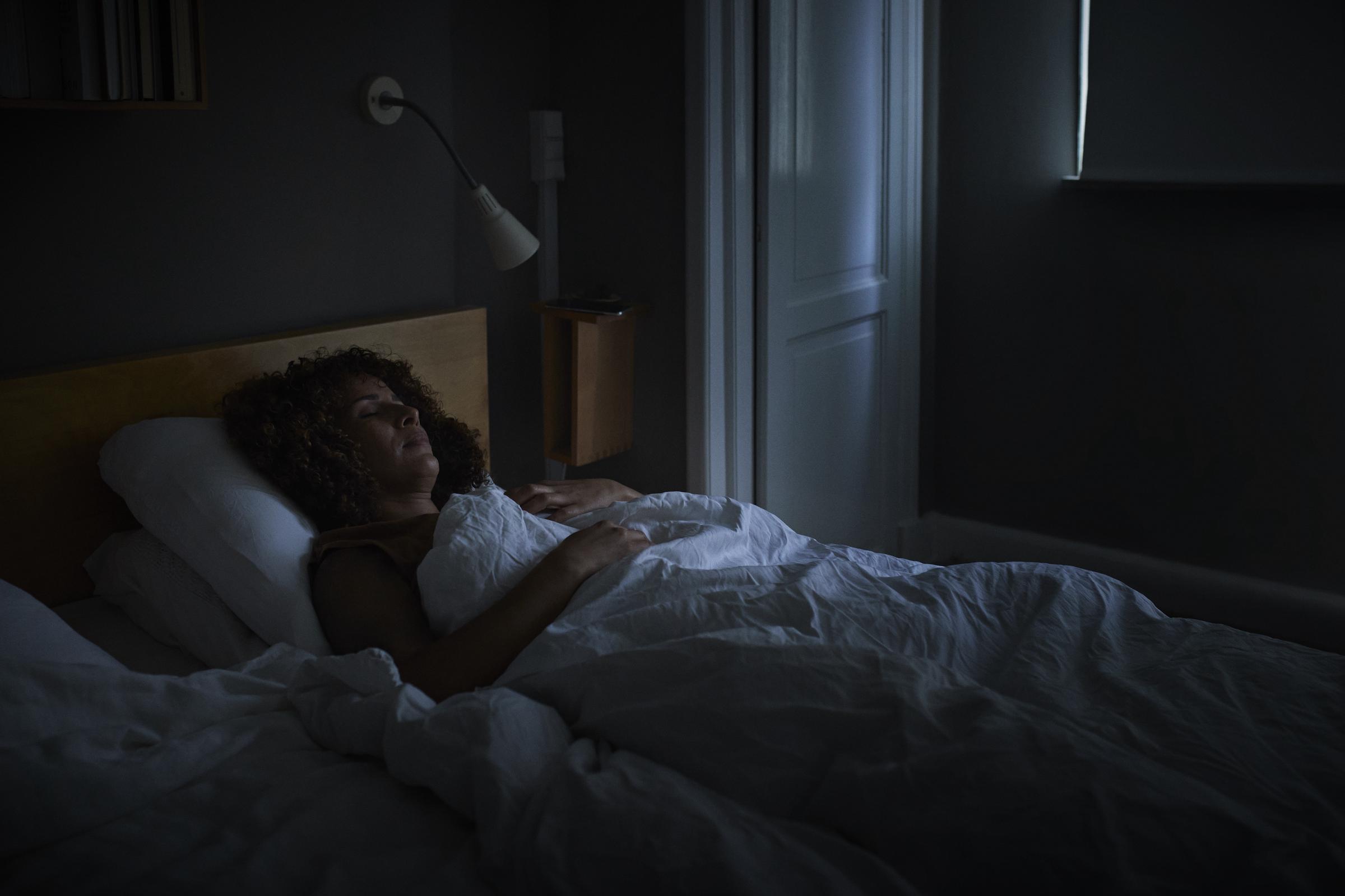 A woman sleeping on her bed | Source: Getty Images