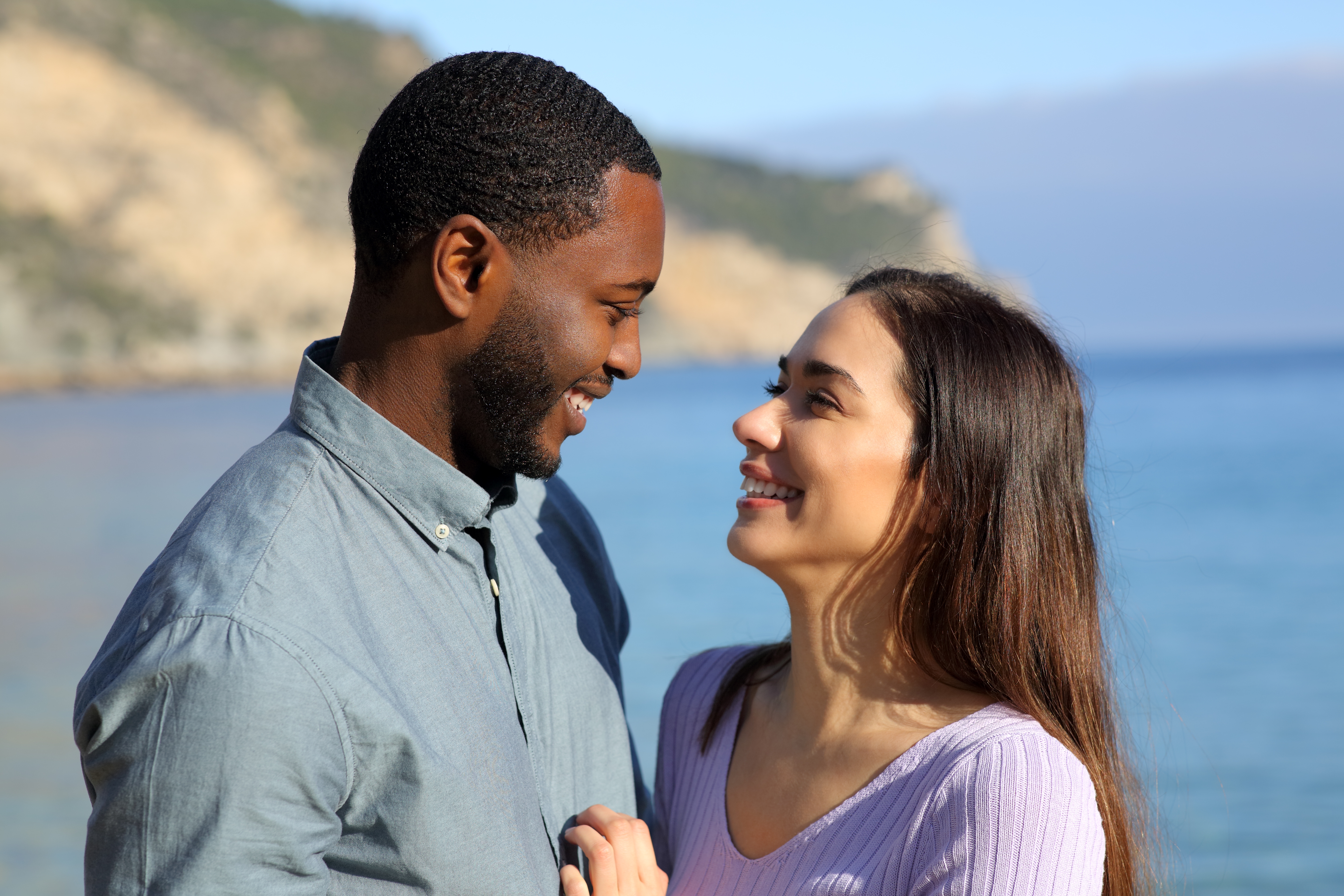Interracial couple looking at each other | Source: Shutterstock