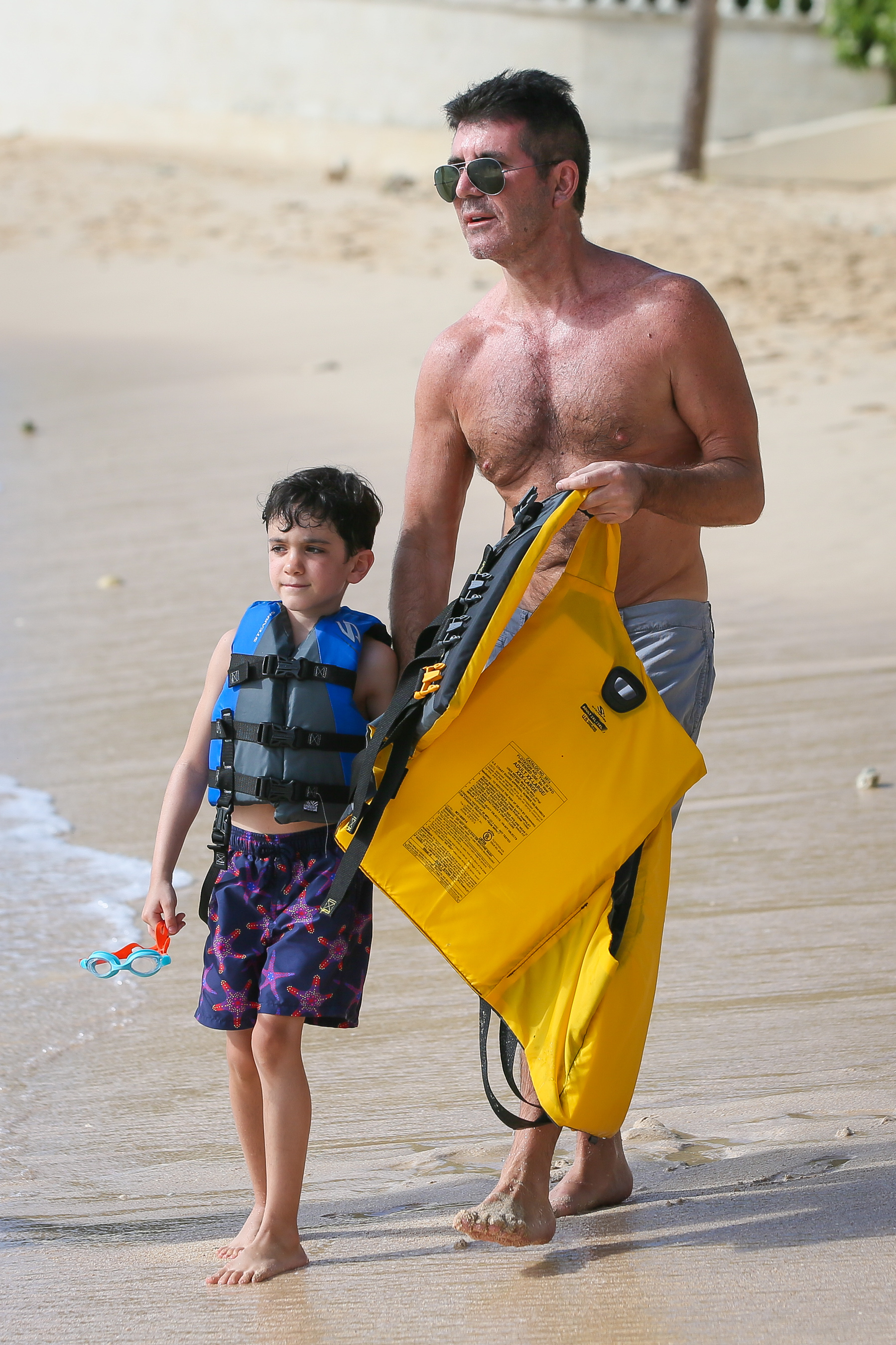 Simon Cowell is seen with his son Eric Cowell on the beach, on December 22, 2019, in Bridgetown, Barbados. | Source: Getty Images