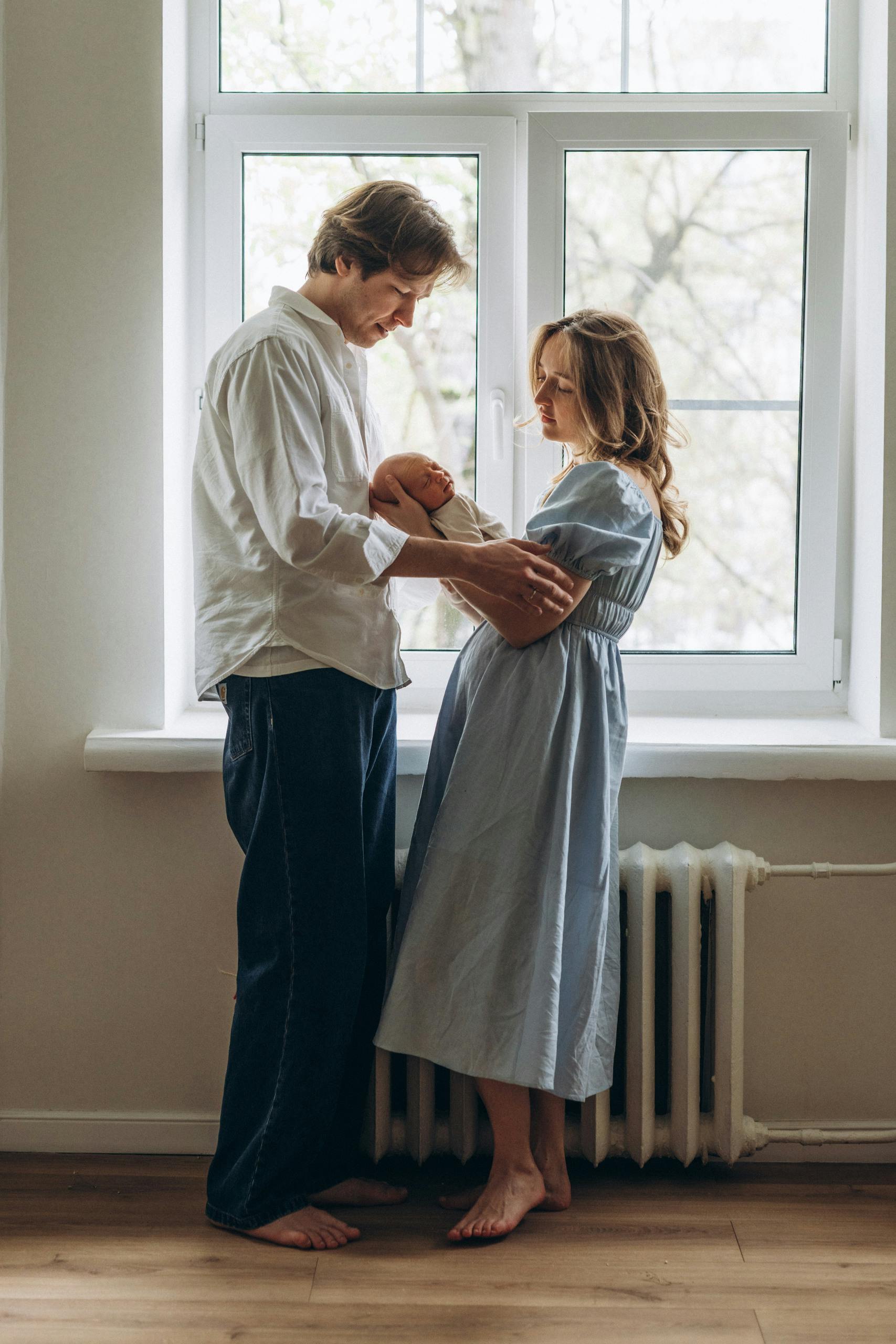 A couple holding their newborn baby | Source: Pexels