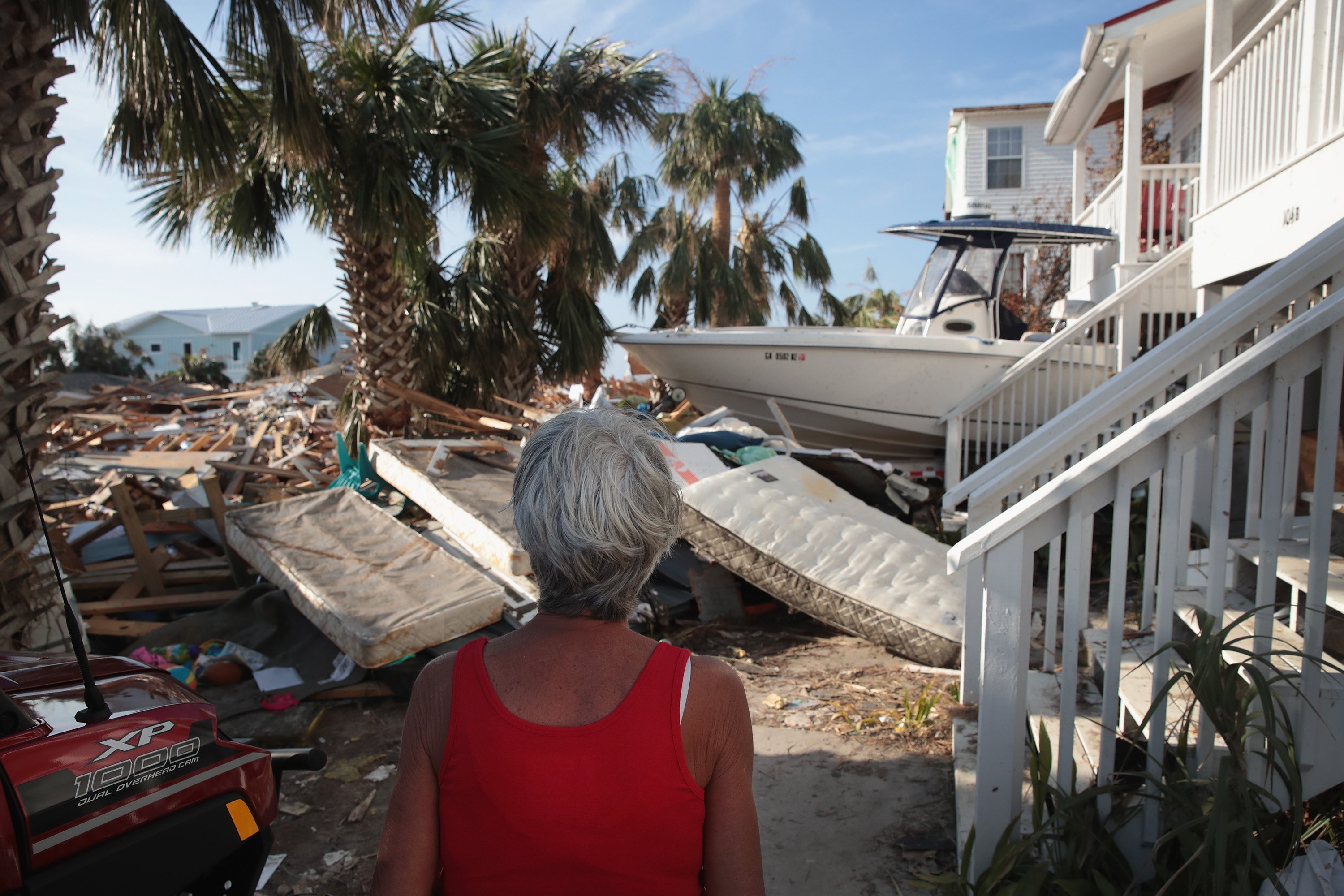 LeClaire Bryan in front of her ruined house in 2018 | Source: Getty Images