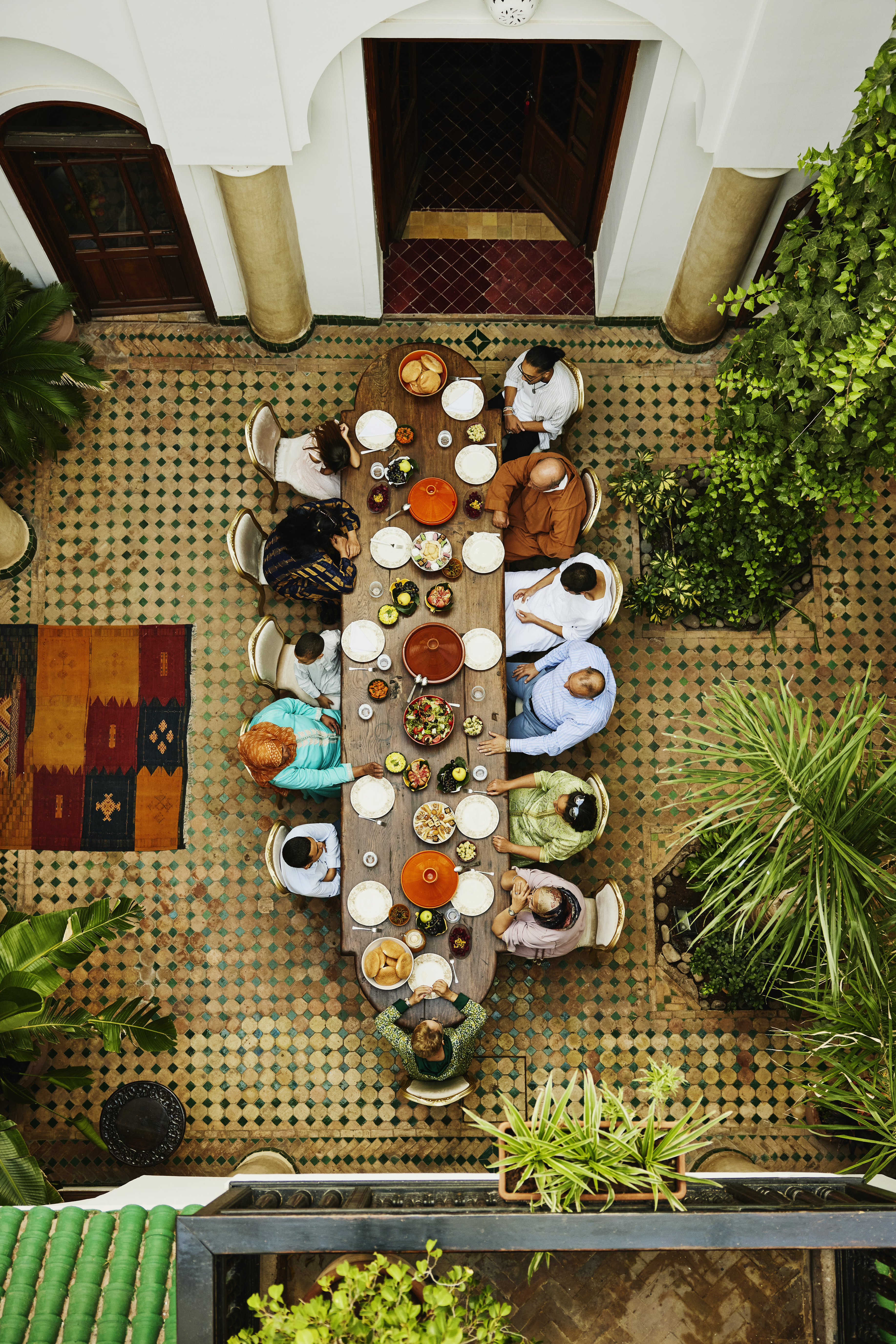 A large dinner table with people sitting around it | Source: Getty Images