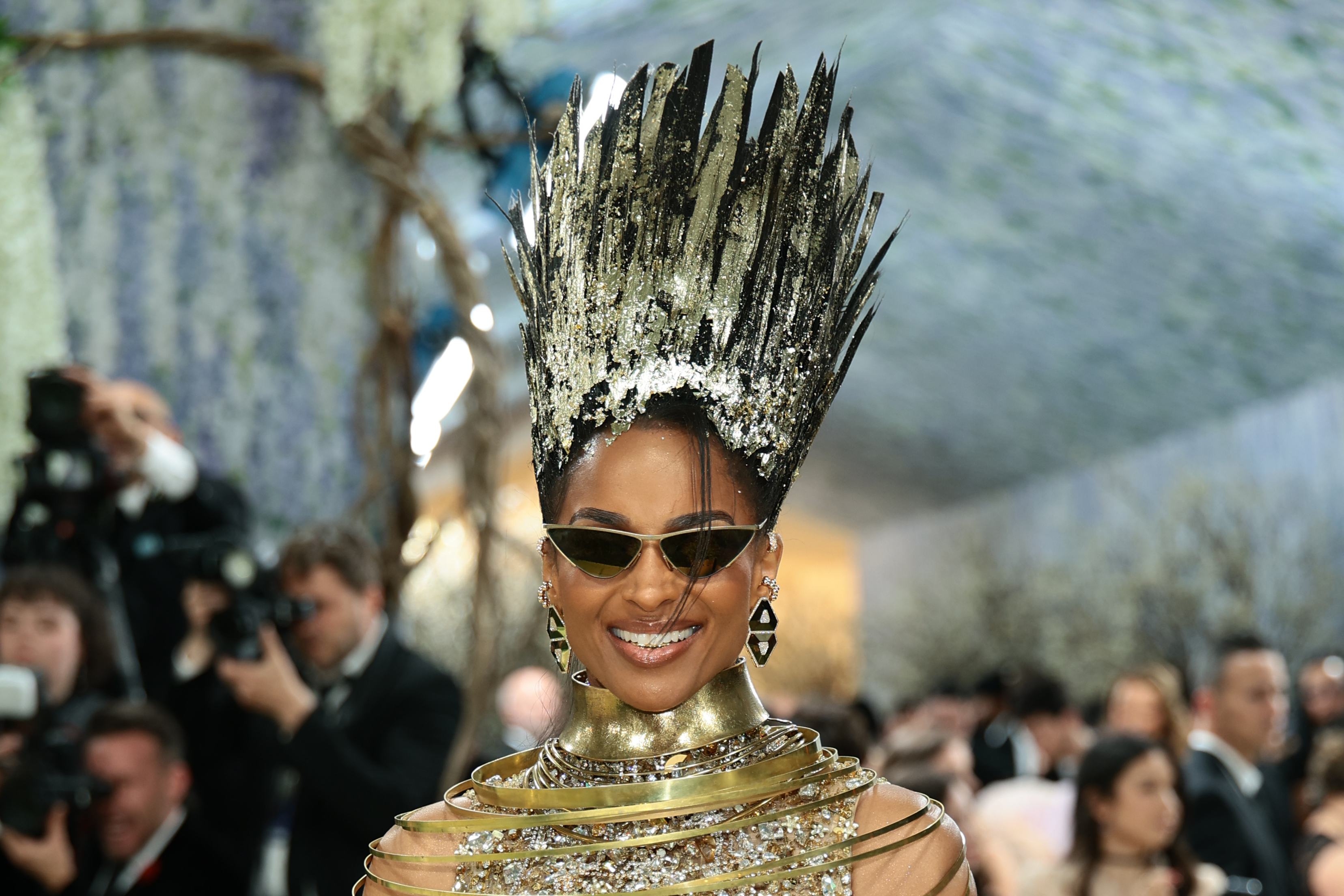 Ciara arrives in a striking gold ensemble with architectural elements | Source: Getty Images