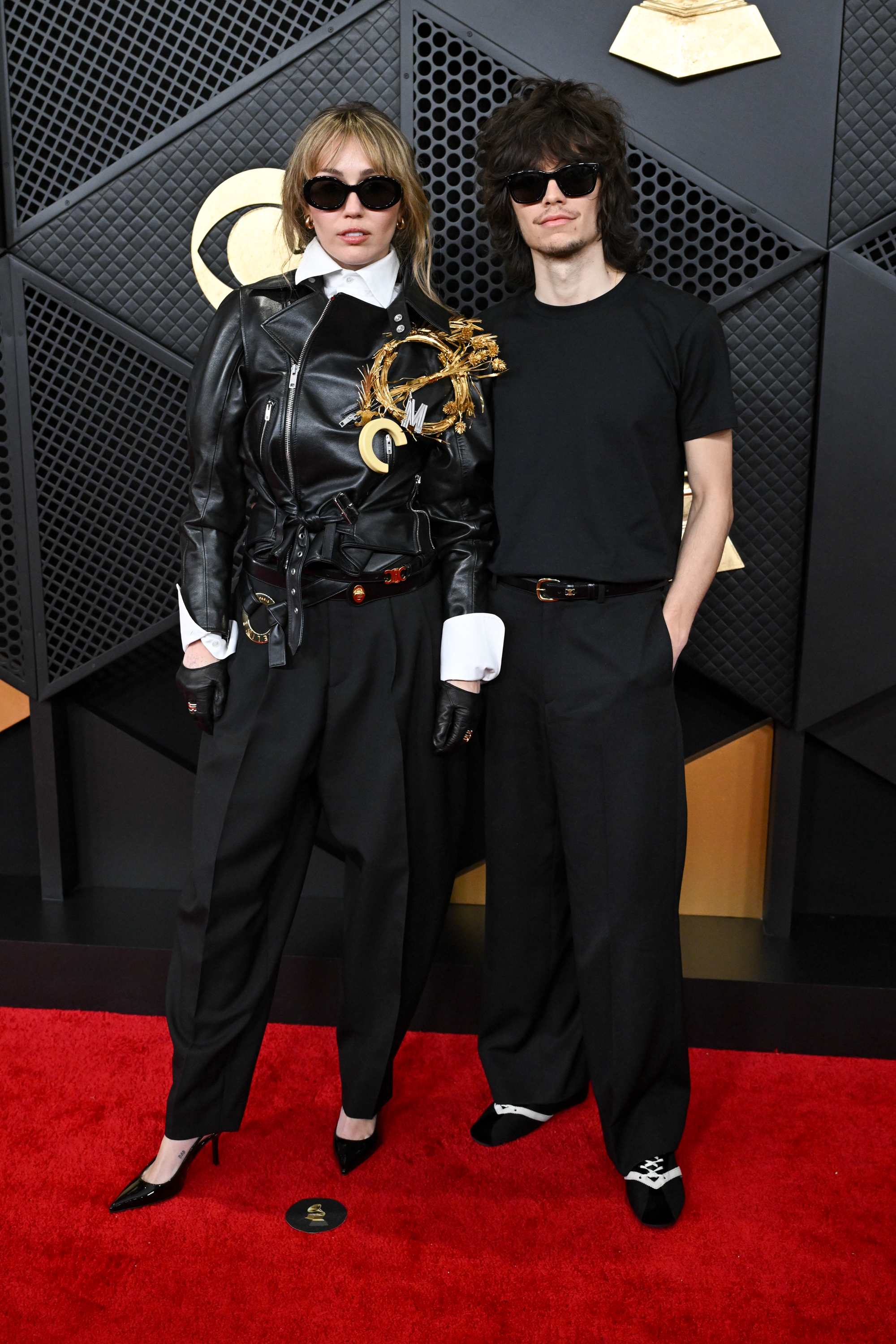 Miley Cyrus and Maxx Morando stand side by side and face photographers during arrivals | Source: Getty Images