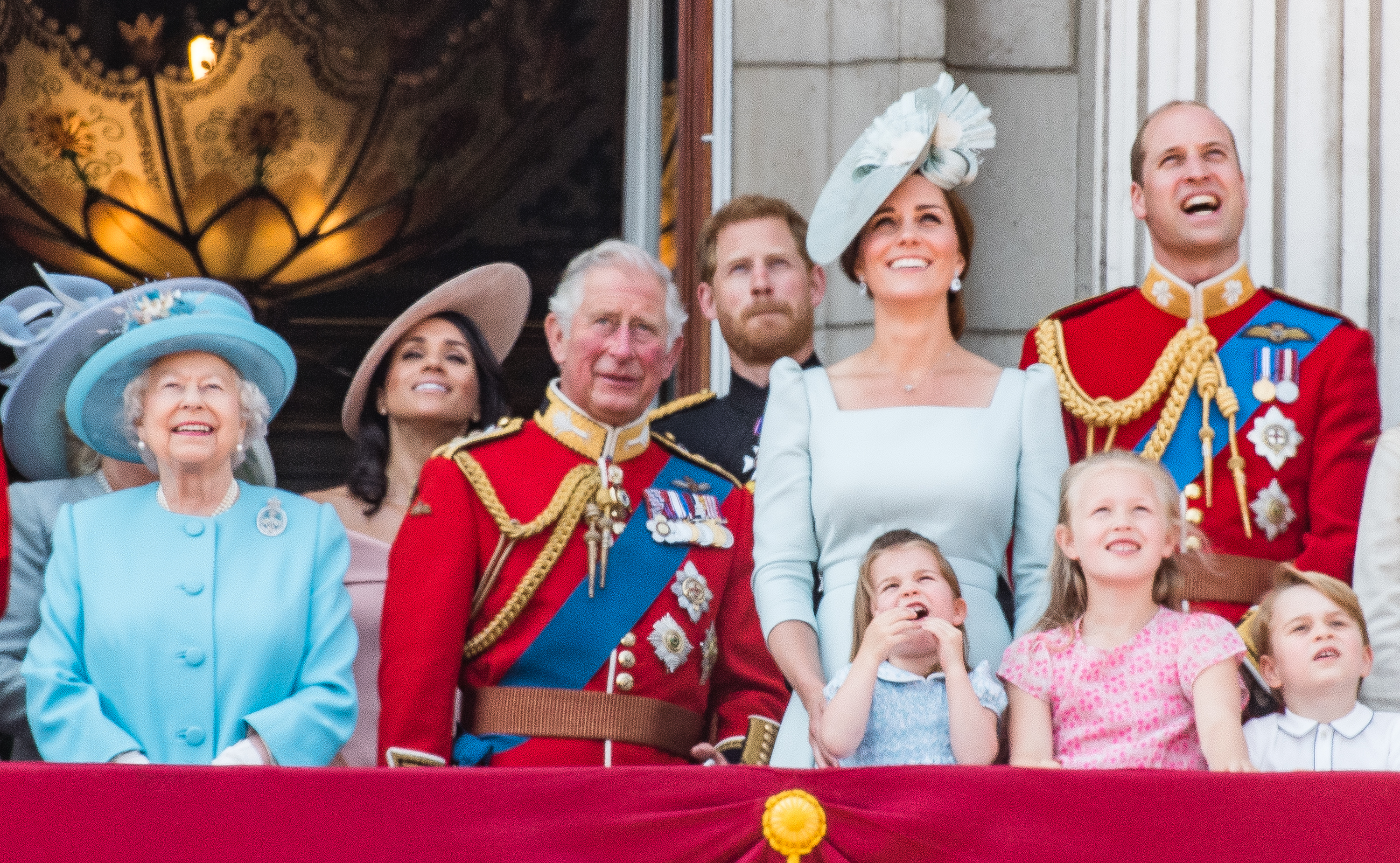 Queen Elizabeth II, Meghan, Prince Charles, Prince Harry, Catherine, Princess Charlotte, Savannah Phillips, Prince William, and Prince George on the balcony of Buckingham Palace on June 9, 2018 in London, England | Source: Getty Images