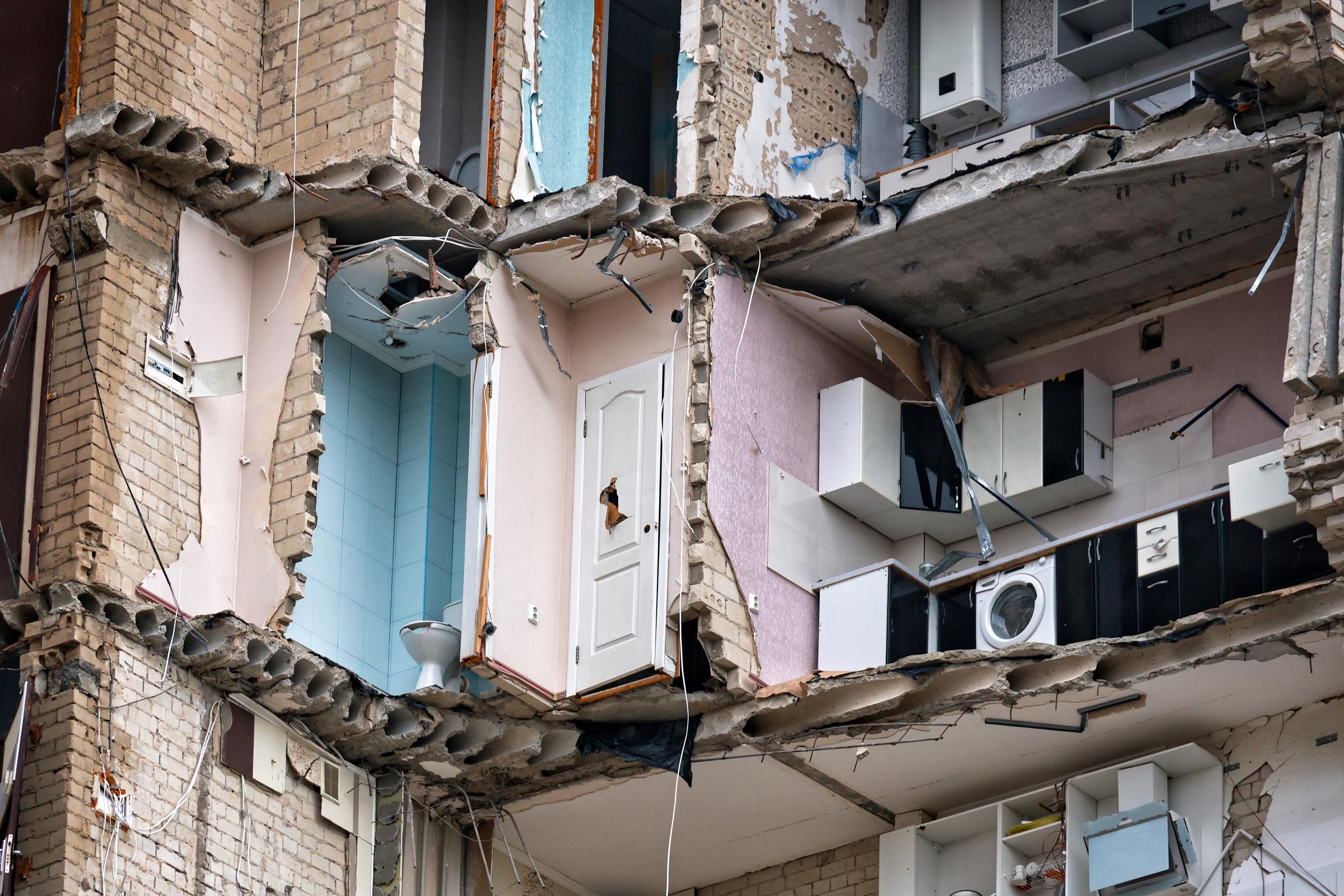 Kitchen cabinets cling to the wall of a shelled apartment block in front-line Kherson, Ukraine, on October 2, 2025. | Source: Getty Images