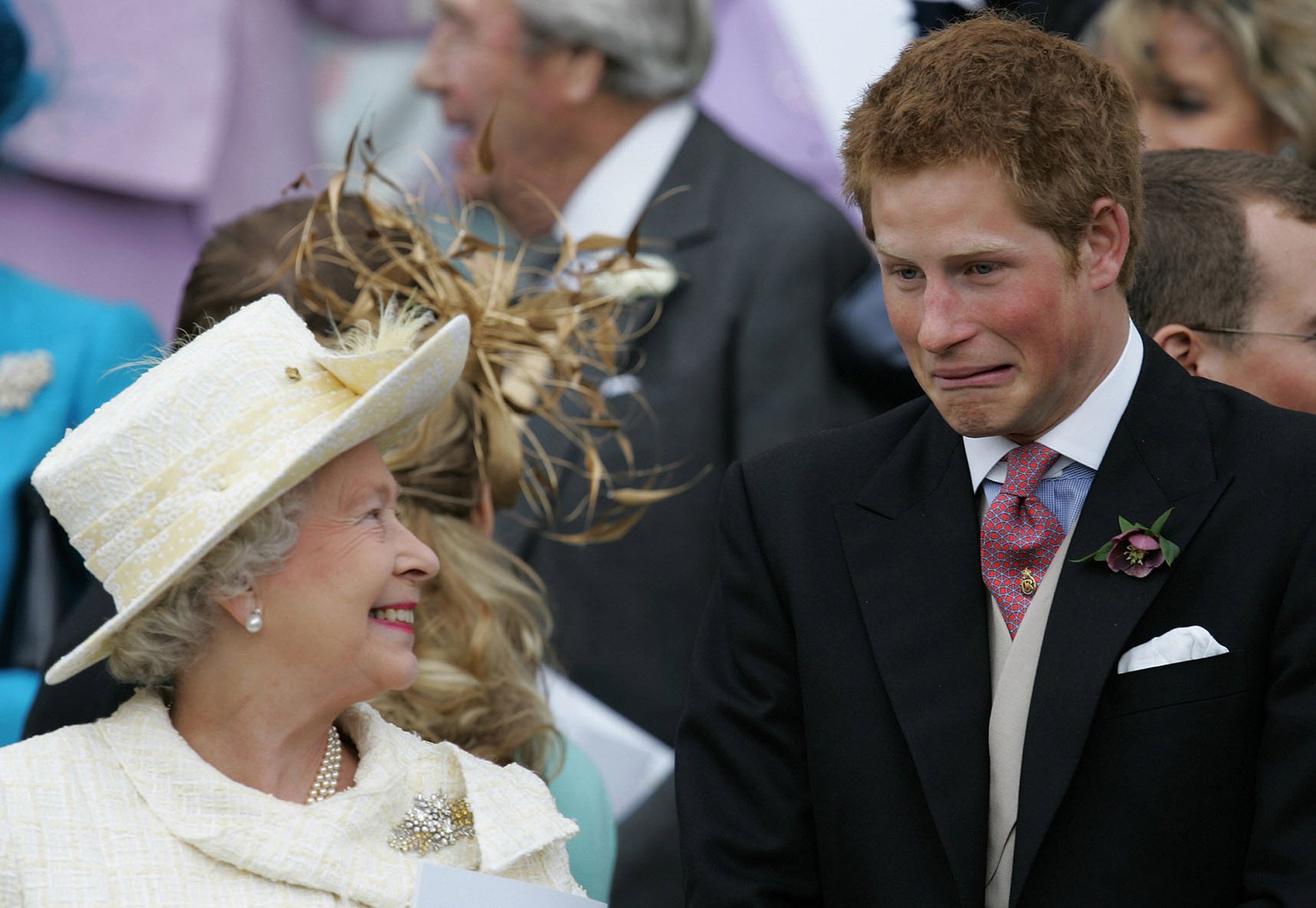 Queen Elizabeth II and her grandson Prince Harry watch as Prince Charles and Camilla, Duchess of Cornwall leave St George's Chapel following their marriage blessing on April 9, 2005 in Windsor, United Kingdom┃Source: Getty Images